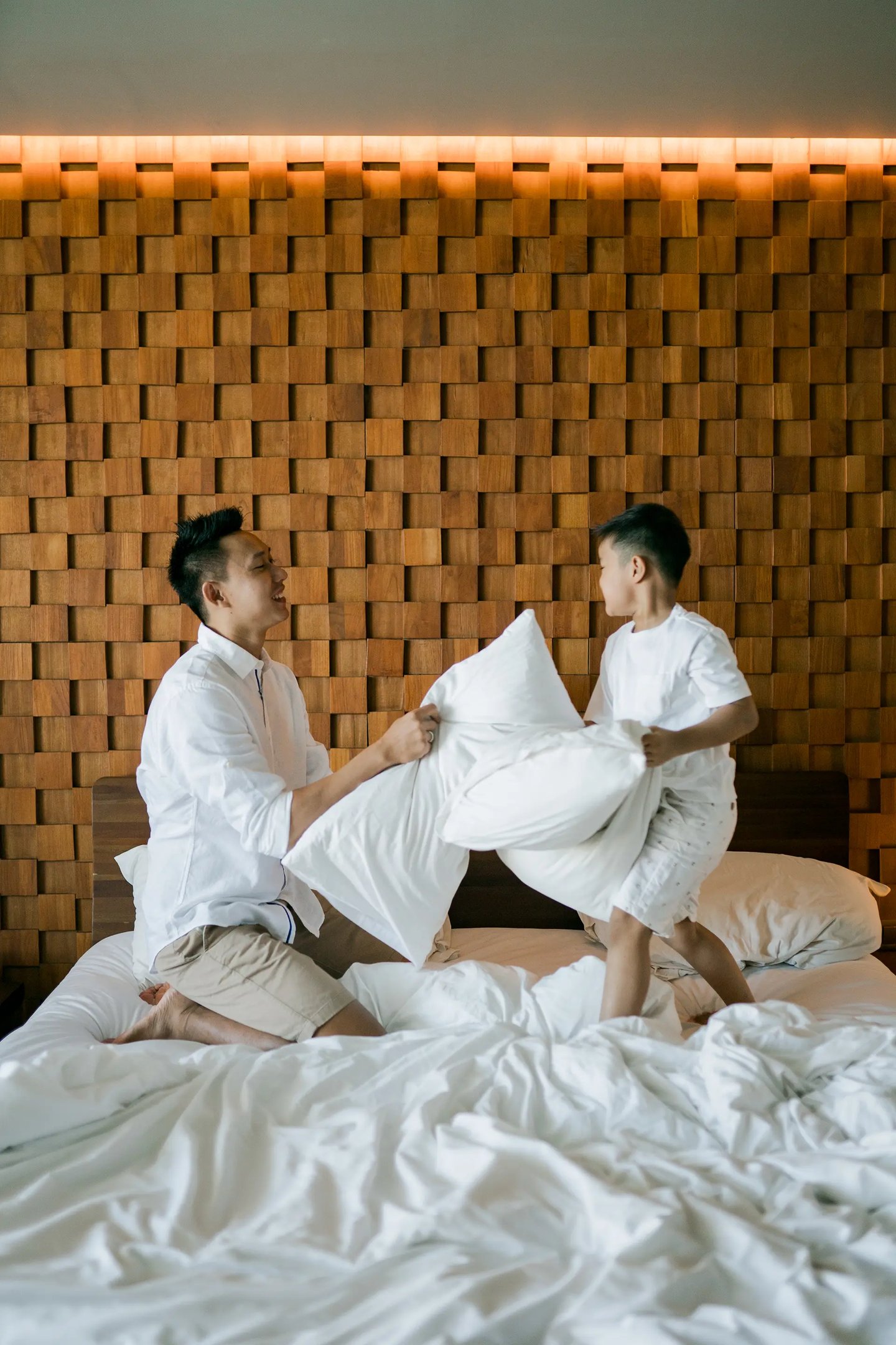 Parents sharing a quiet indoor family moment at Anantara Uluwatu Bali.