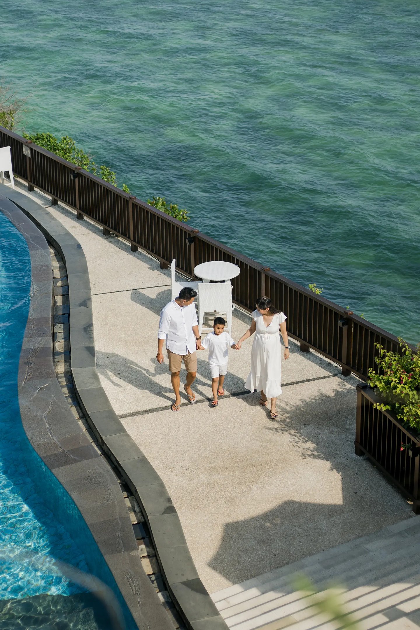 Family walking by the ocean during a relaxed family session at Anantara Uluwatu.