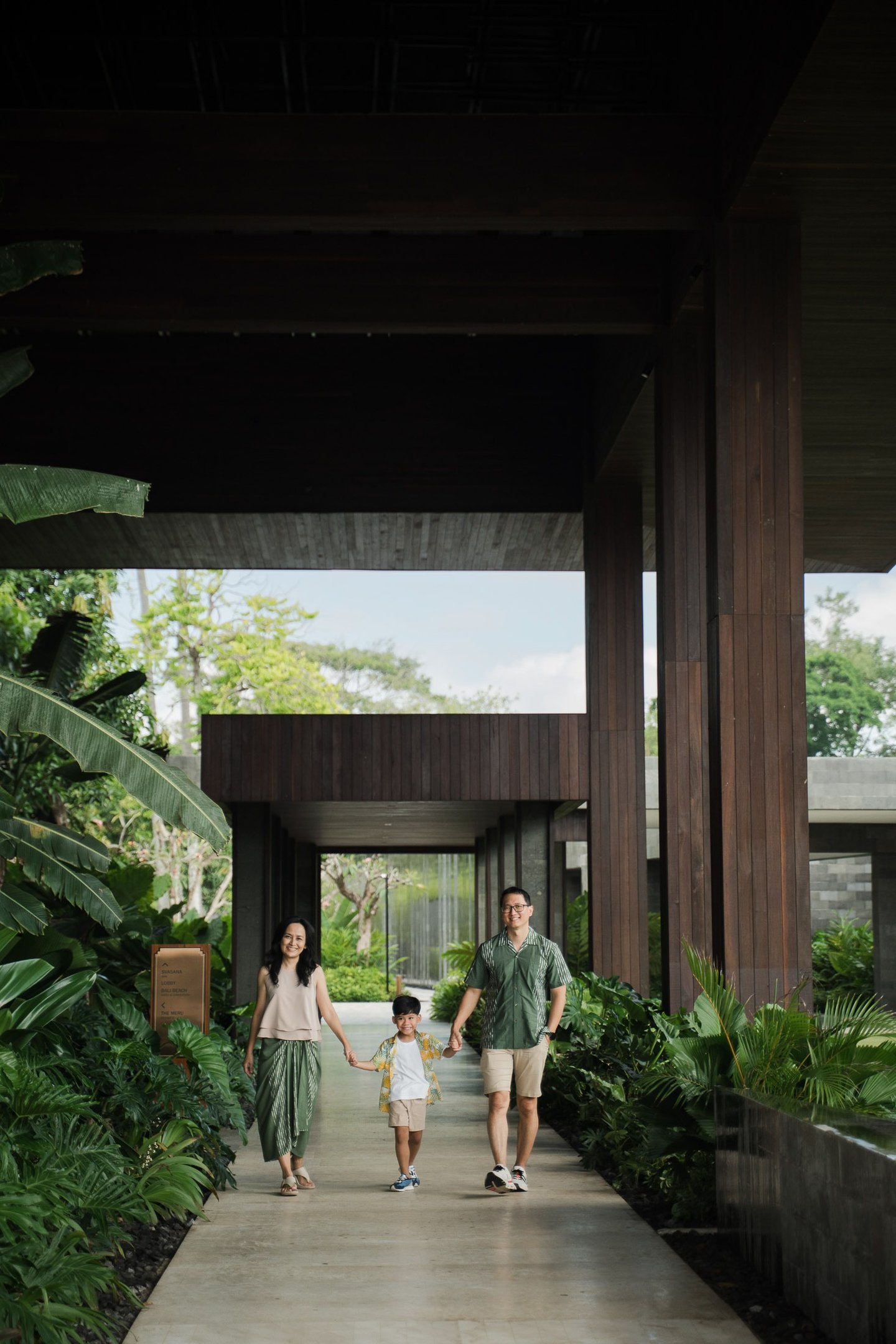 Parents walking with their children at The Meru Sanur Bali family photography session