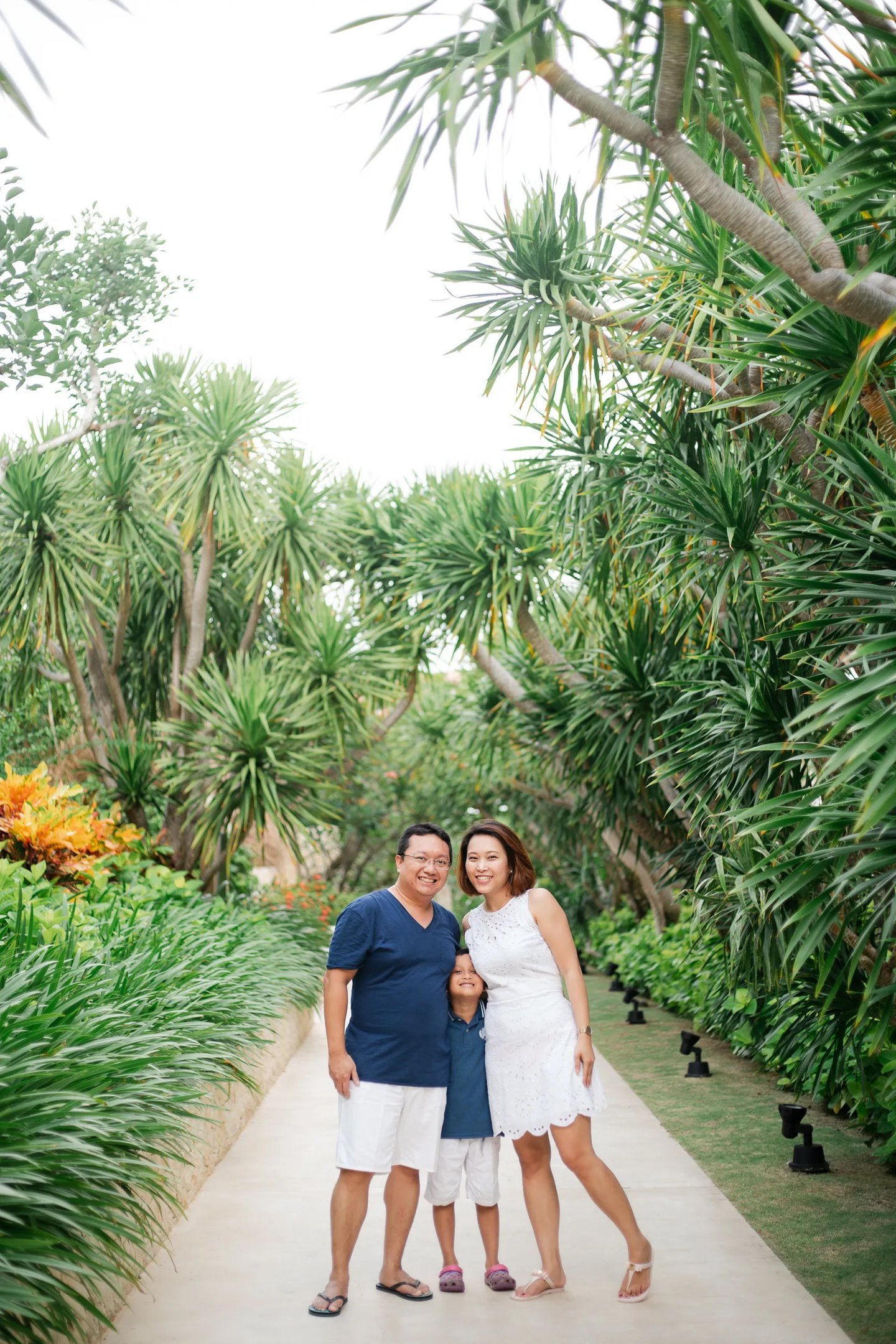 Family portrait surrounded by tropical garden at The Mulia Nusa Dua Bali