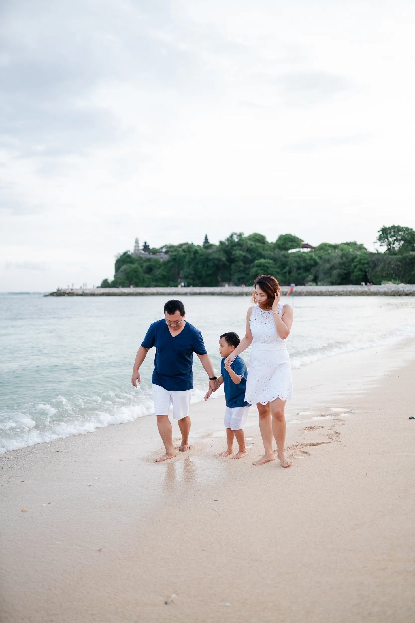 Family walking together during beach session at The Mulia Nusa Dua Bali