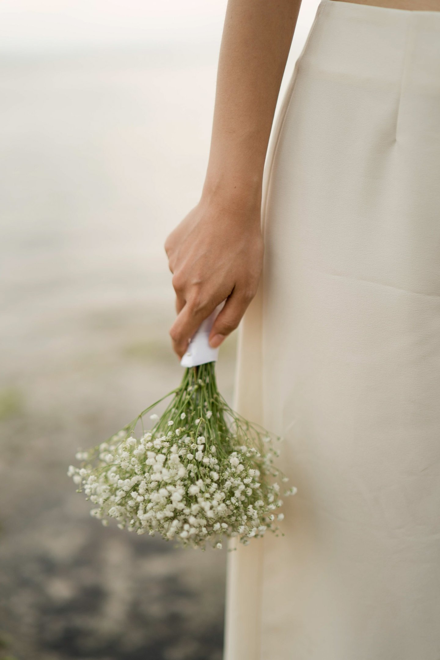 Bride holding bouquet detail during bridal portrait session at Melasti Beach Bali