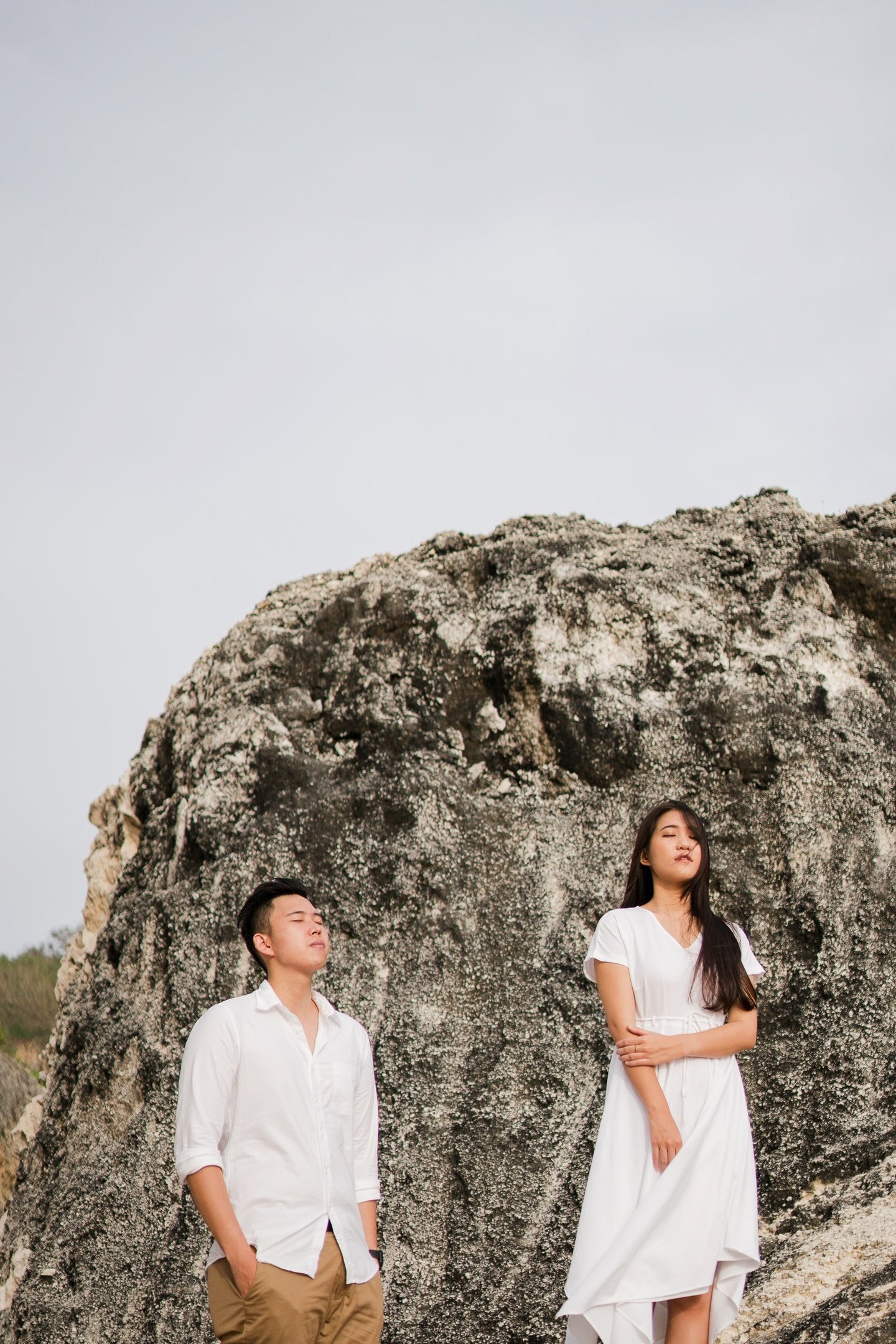 Couple portrait on a rocky cliff during proposal photoshoot at Melasti Beach Bali