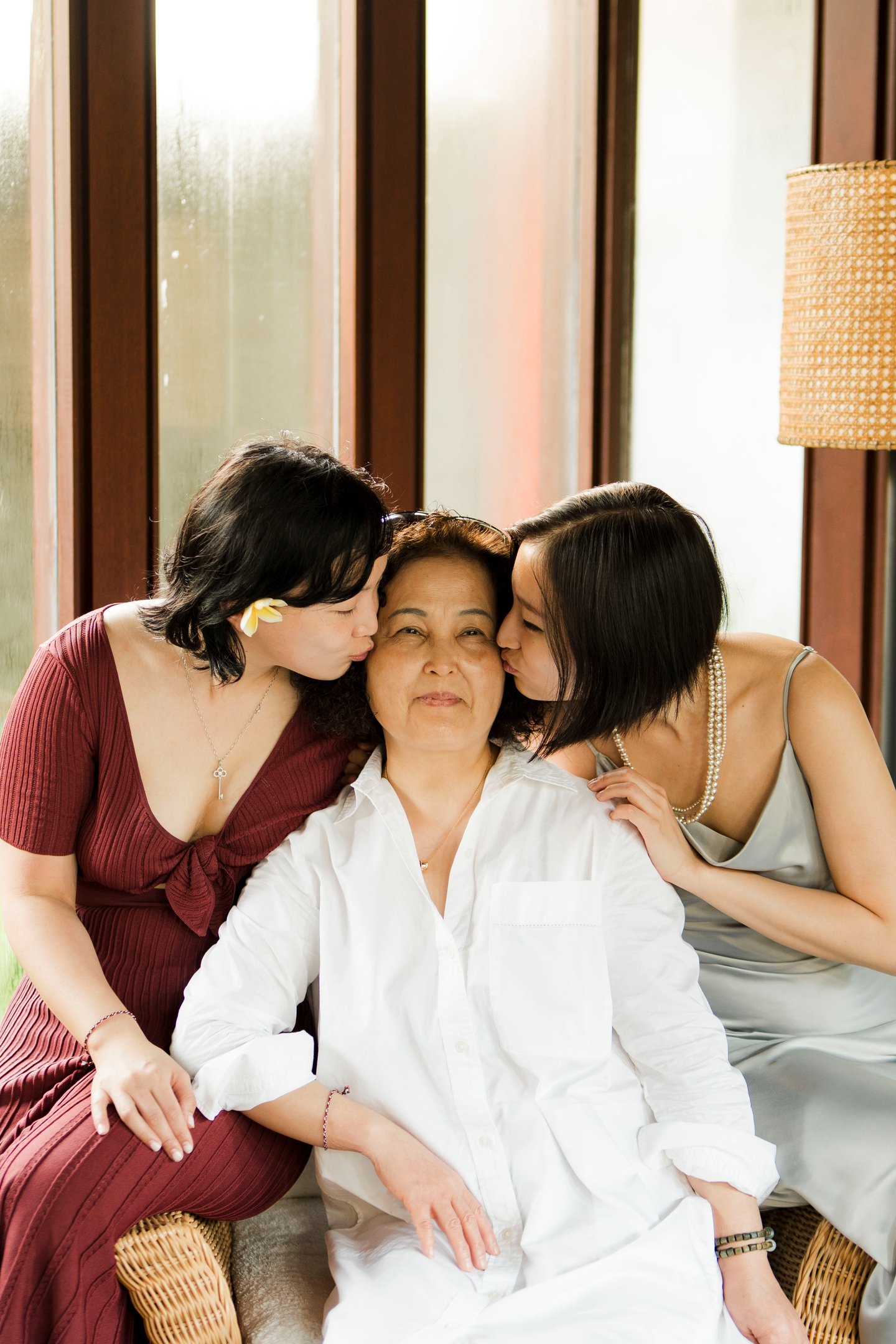 luxury family photography at Bulgari Resort Bali capturing mother and daughters in natural window light