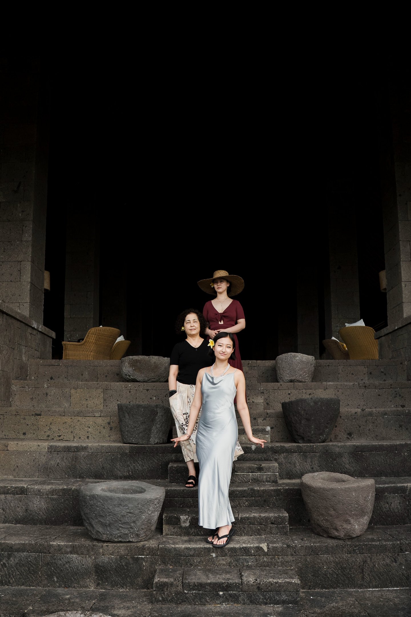 family portrait at Bulgari Resort Bali in Uluwatu framed by dramatic stone architecture