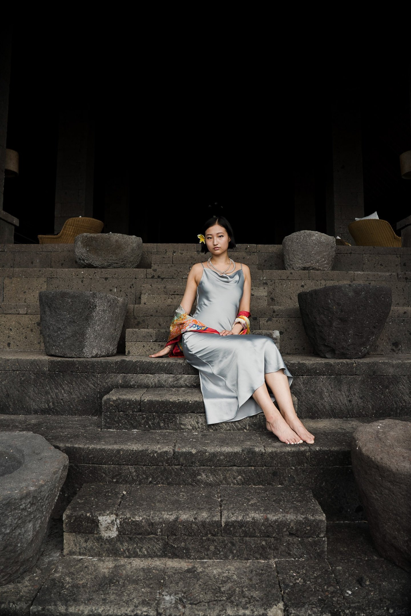 Daughter portrait seated on stone steps at Bvlgari Resort Uluwatu Bali, timeless luxury portrait photography in Bali