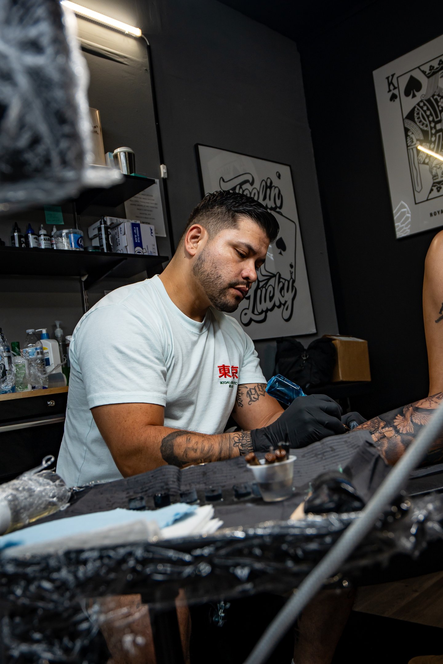 Junior doing a leg sleeve tattoo at royal nine tattoo