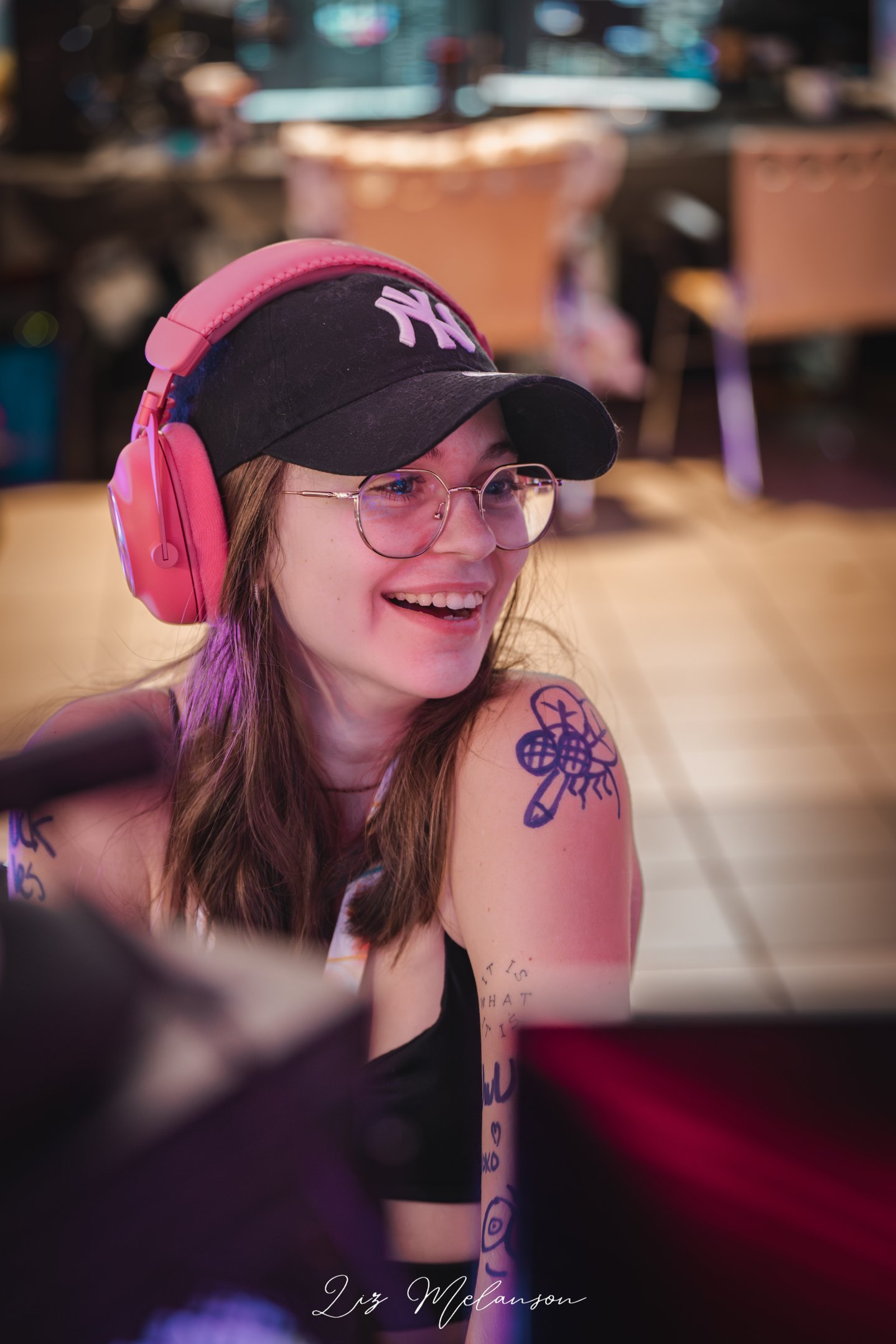 a woman with a baseball cap and headphones