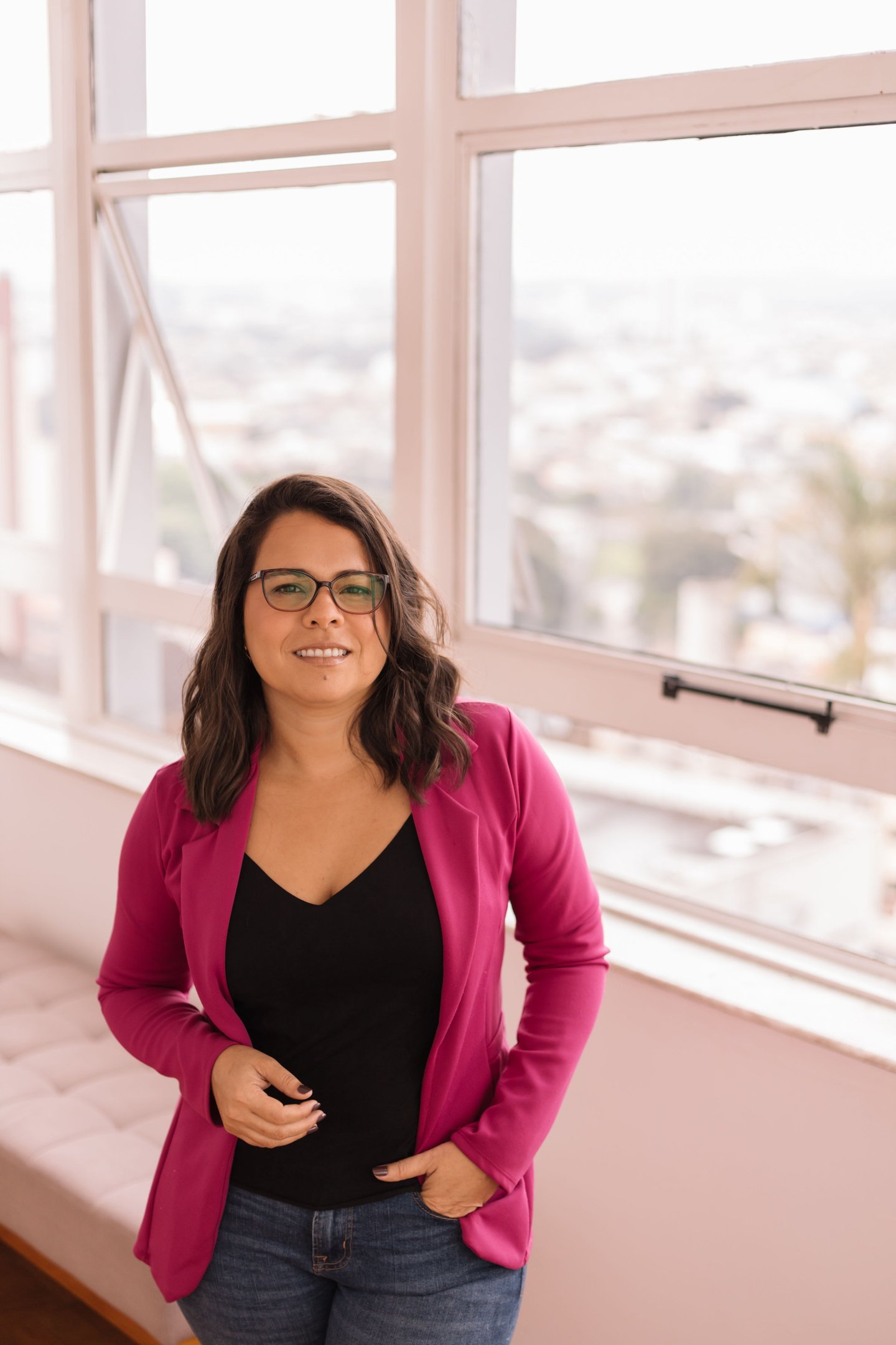a woman therapist in her office in front of a window
