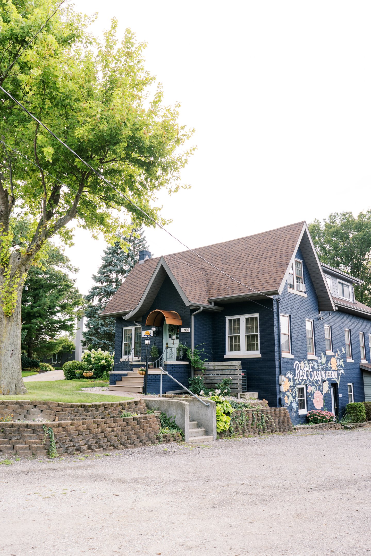 South Cliff Inn exterior, featuring the front door, mural, and parking lot