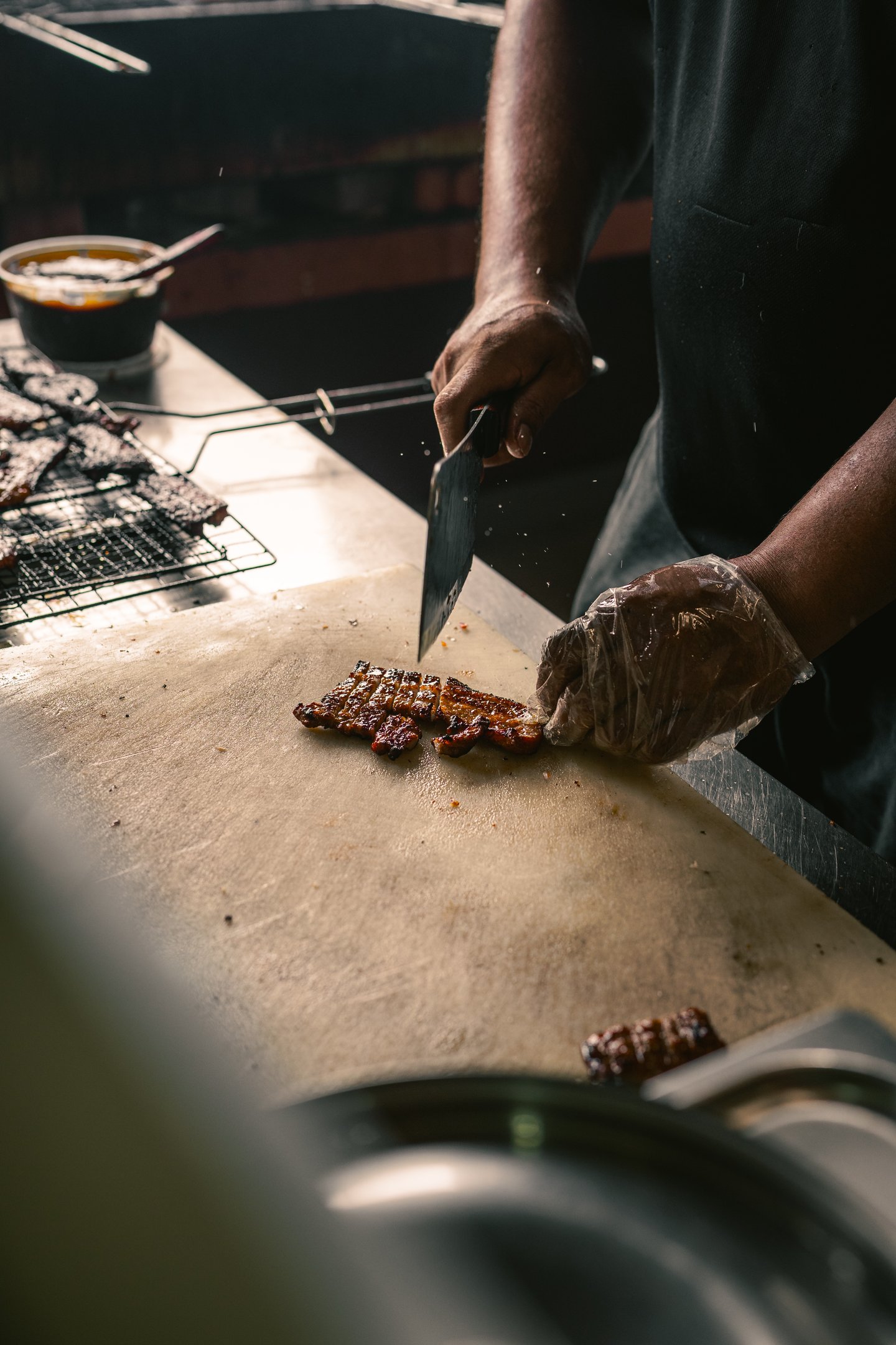 chef chopping grilled pork at BPK Chika Batam