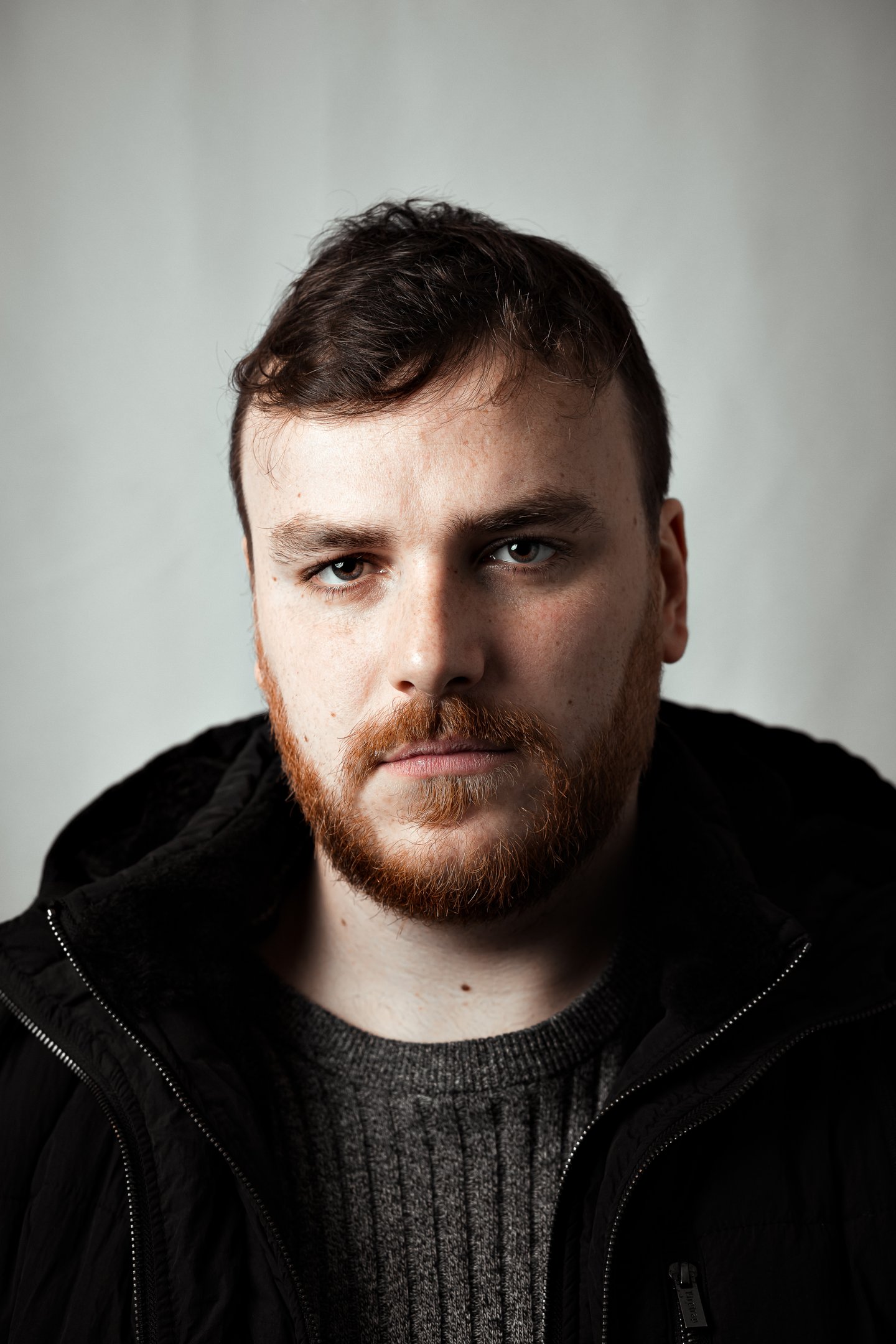 Fine art close-up portrait of a man with intense gaze and soft natural light