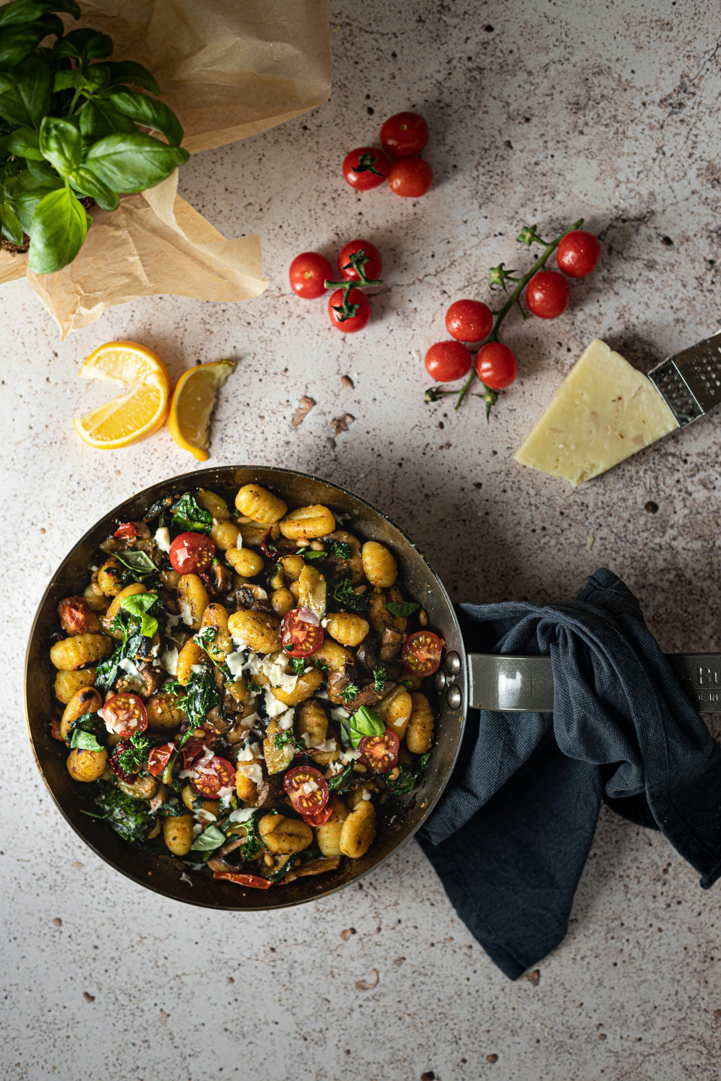 pan of gnocchi, cherry tomatoes, parmesan and basil