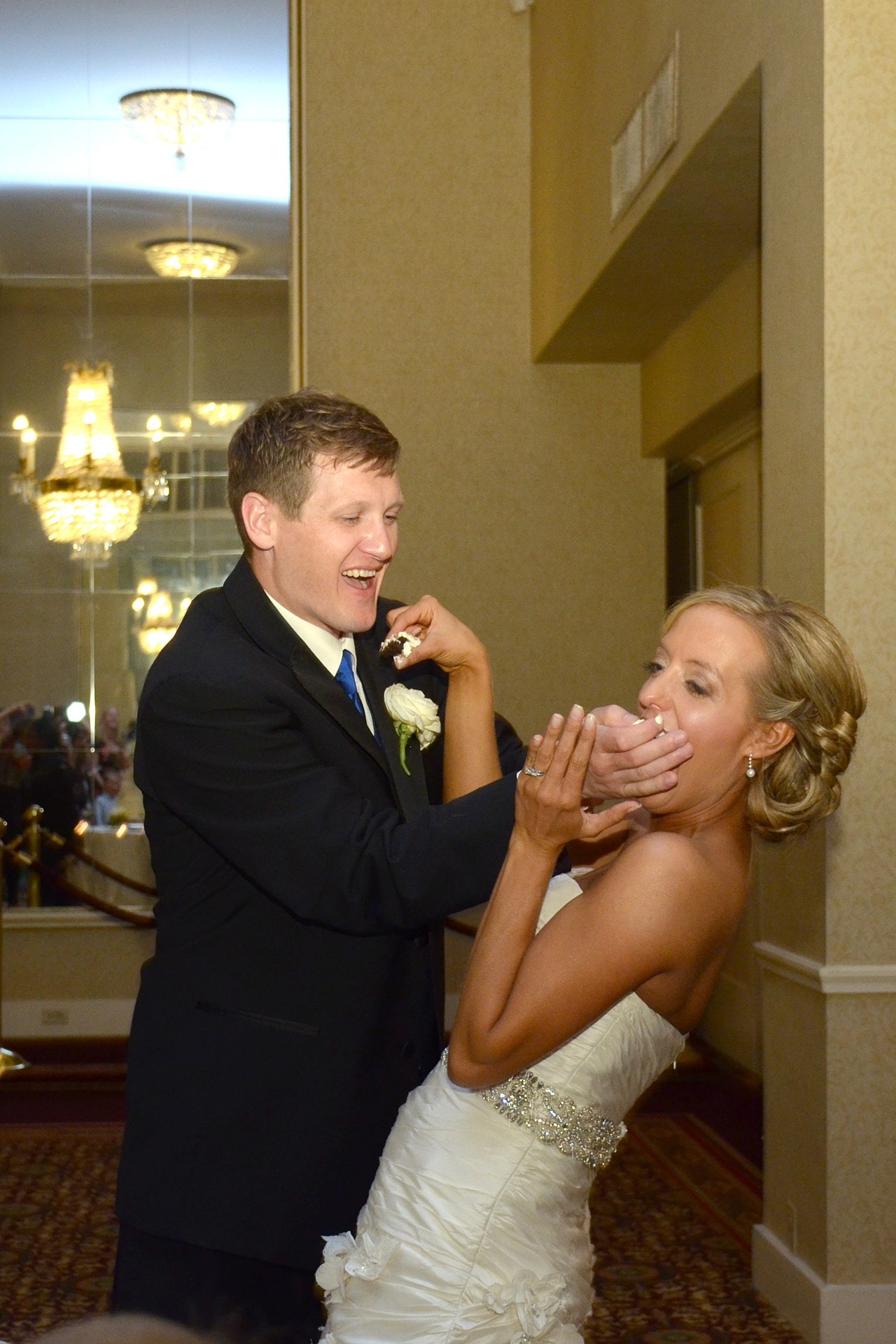 a bride and groom feeding each other a piece of cake