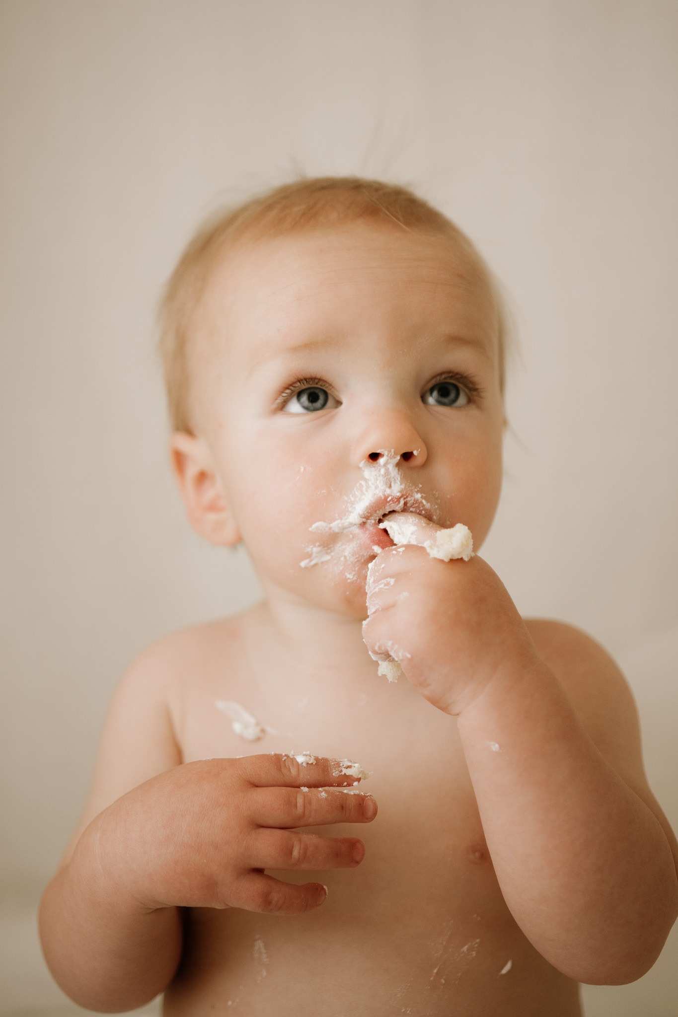 baby eating cake at his cake smash photography session in Adelaide Hills