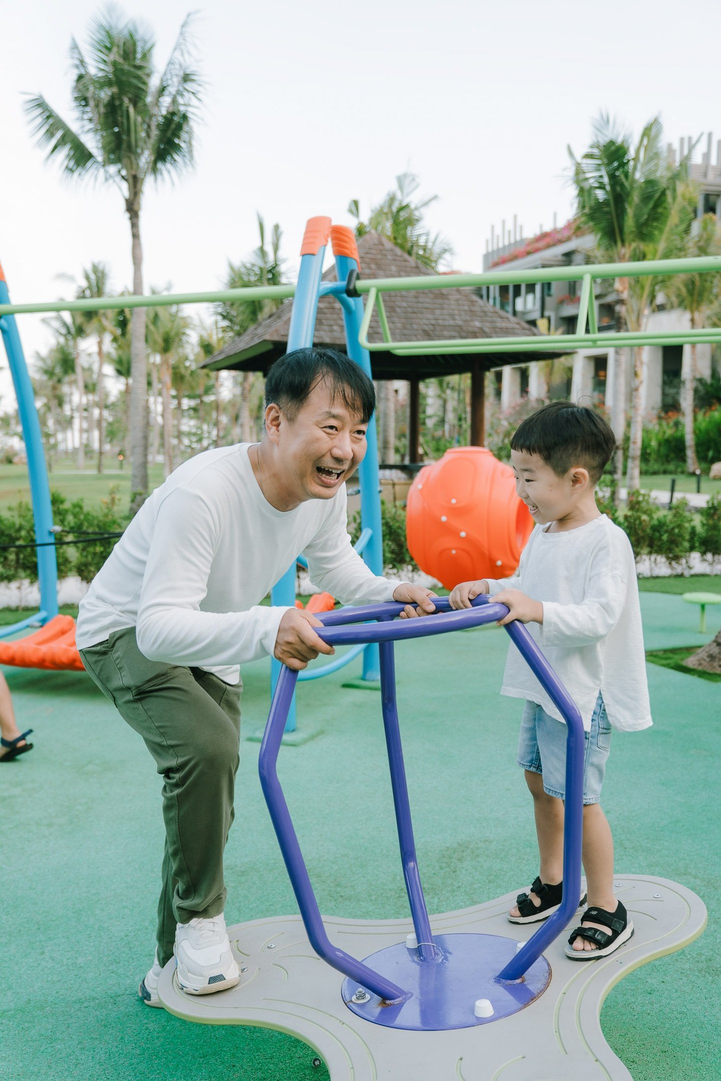 Resort family photography session at The Apurva Kempinski Bali capturing candid family moments at the playground.