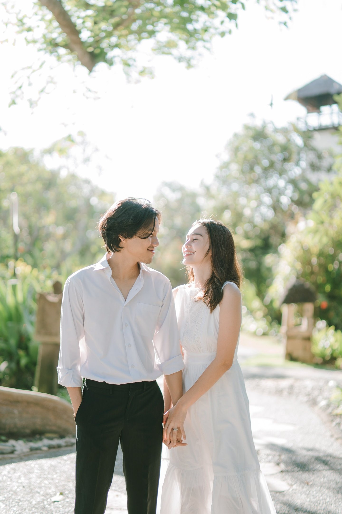 Intimate couple walking along the garden pathway at Novotel Bali Benoa in Tanjung Benoa Bali.