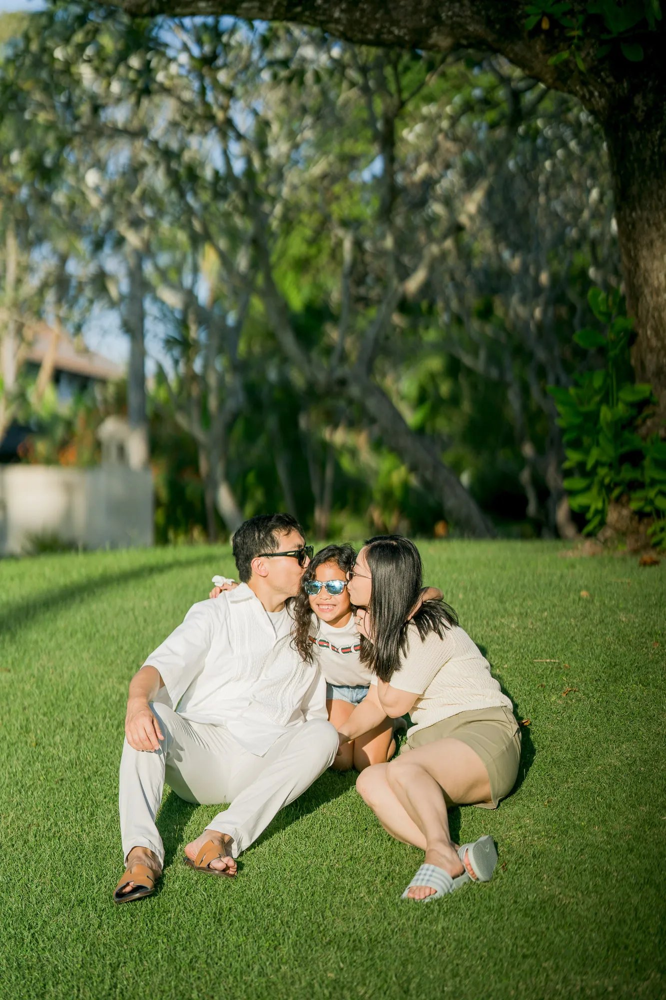 Family enjoying a quiet moment together in the tropical gardens of InterContinental Bali Resort