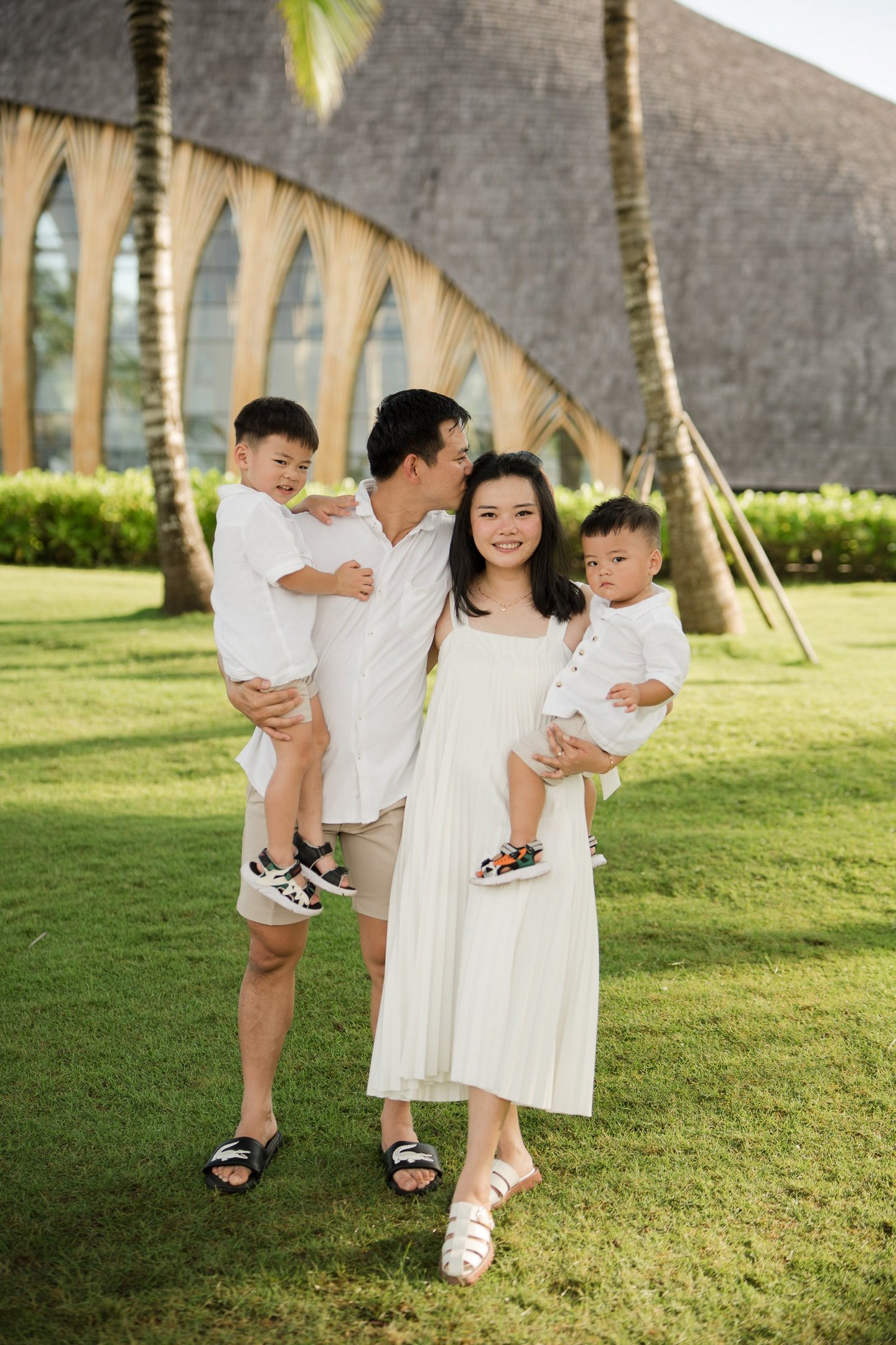 Father carrying his child during a family photography session at The Apurva Kempinski Nusa Dua Bali