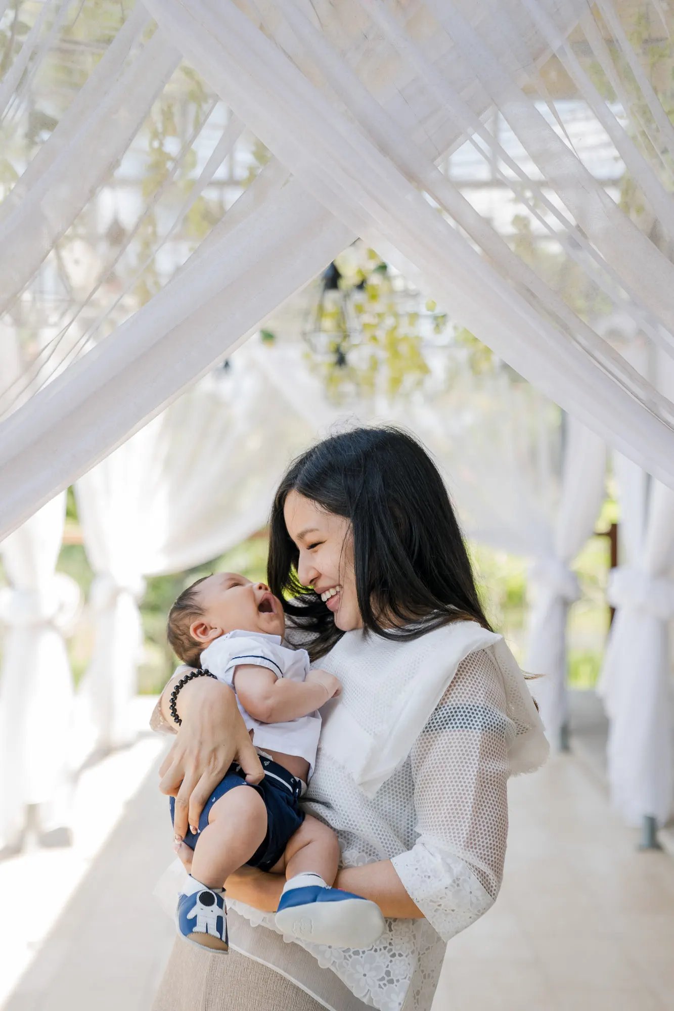 Mother embracing her baby inside a suite at Samabe Bali Suites & Villas in Nusa Dua.