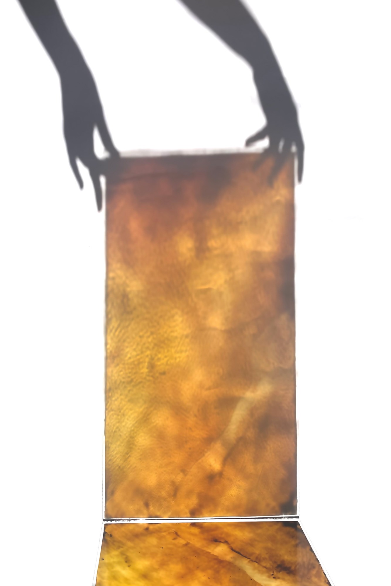 light and shadow play of a glass painting, warm amber glow