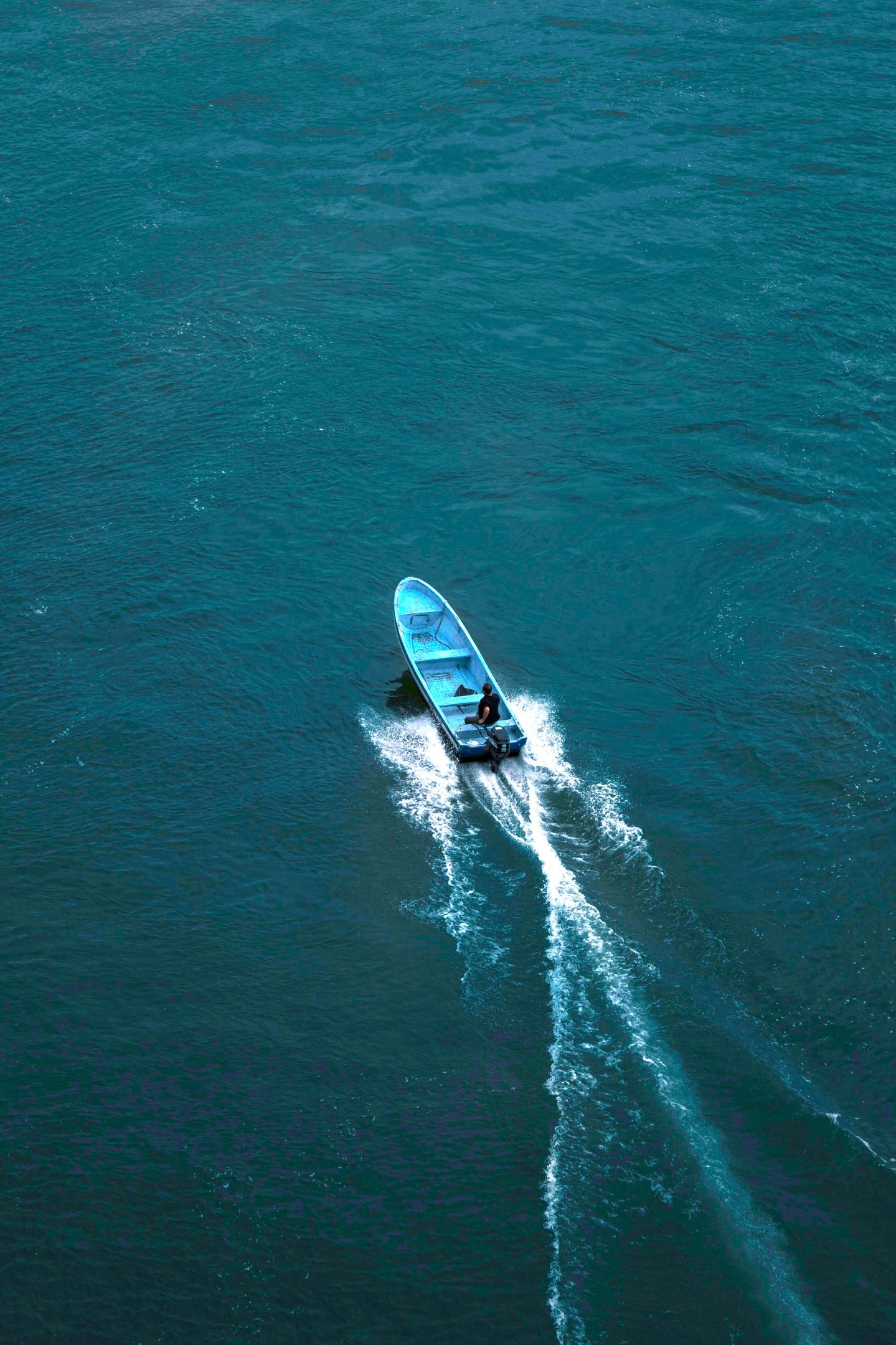 a boat with a blue and white boat in the water
