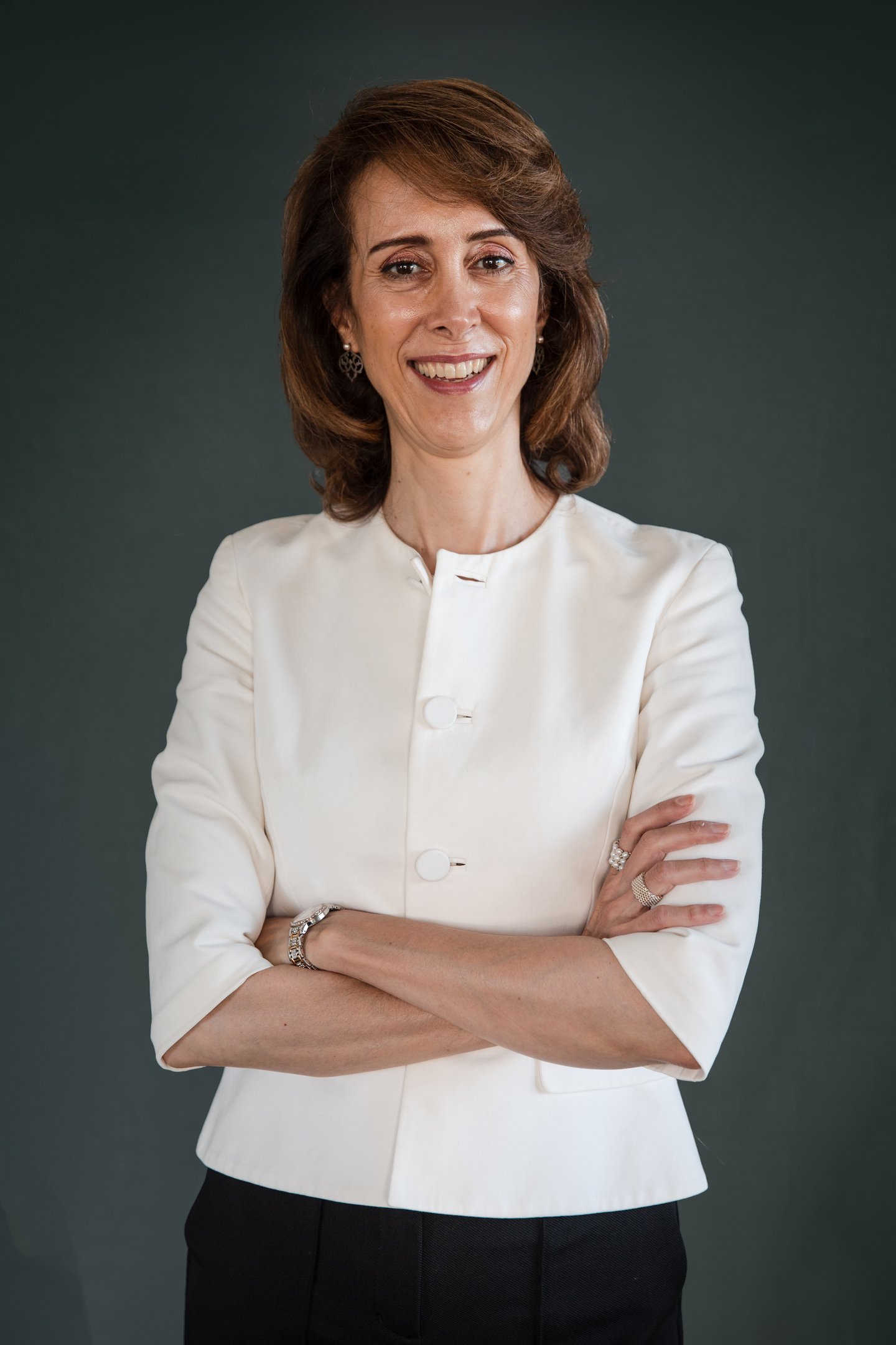 a female life coach in a white jacket and black pants