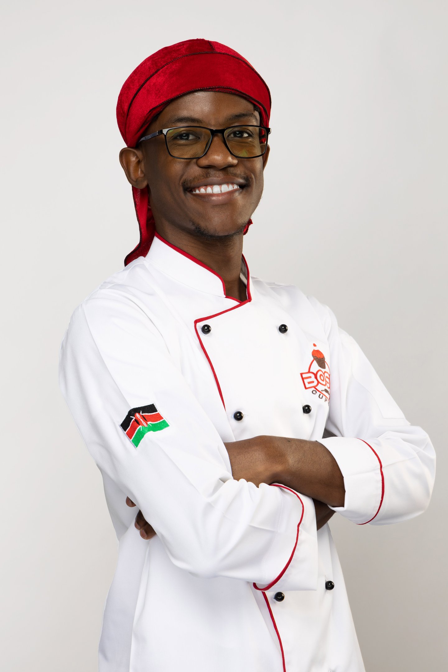 a man in a chef's uniform and a red hat