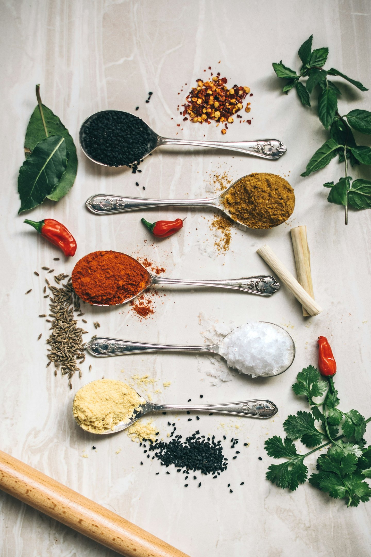 a variety of spices and spices in spoons and spoons