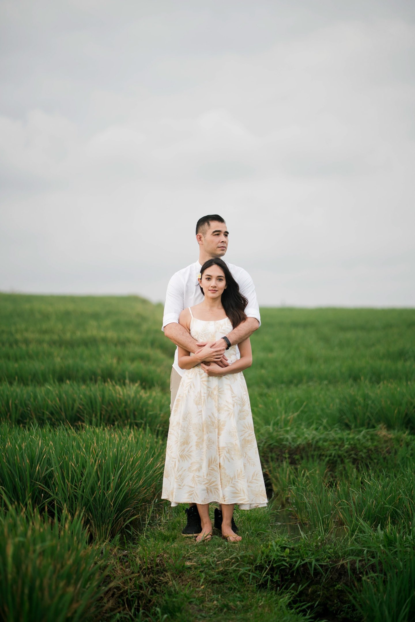 Romantic couple standing together in rice fields at Waka Gangga Tabanan West Bali