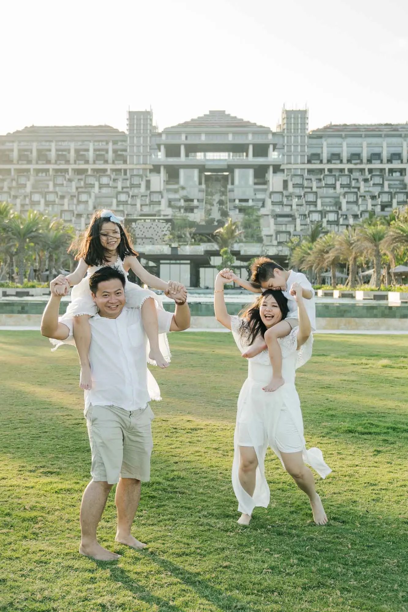 Playful family photography on the Ocean Lawn at The Apurva Kempinski Bali during golden hour