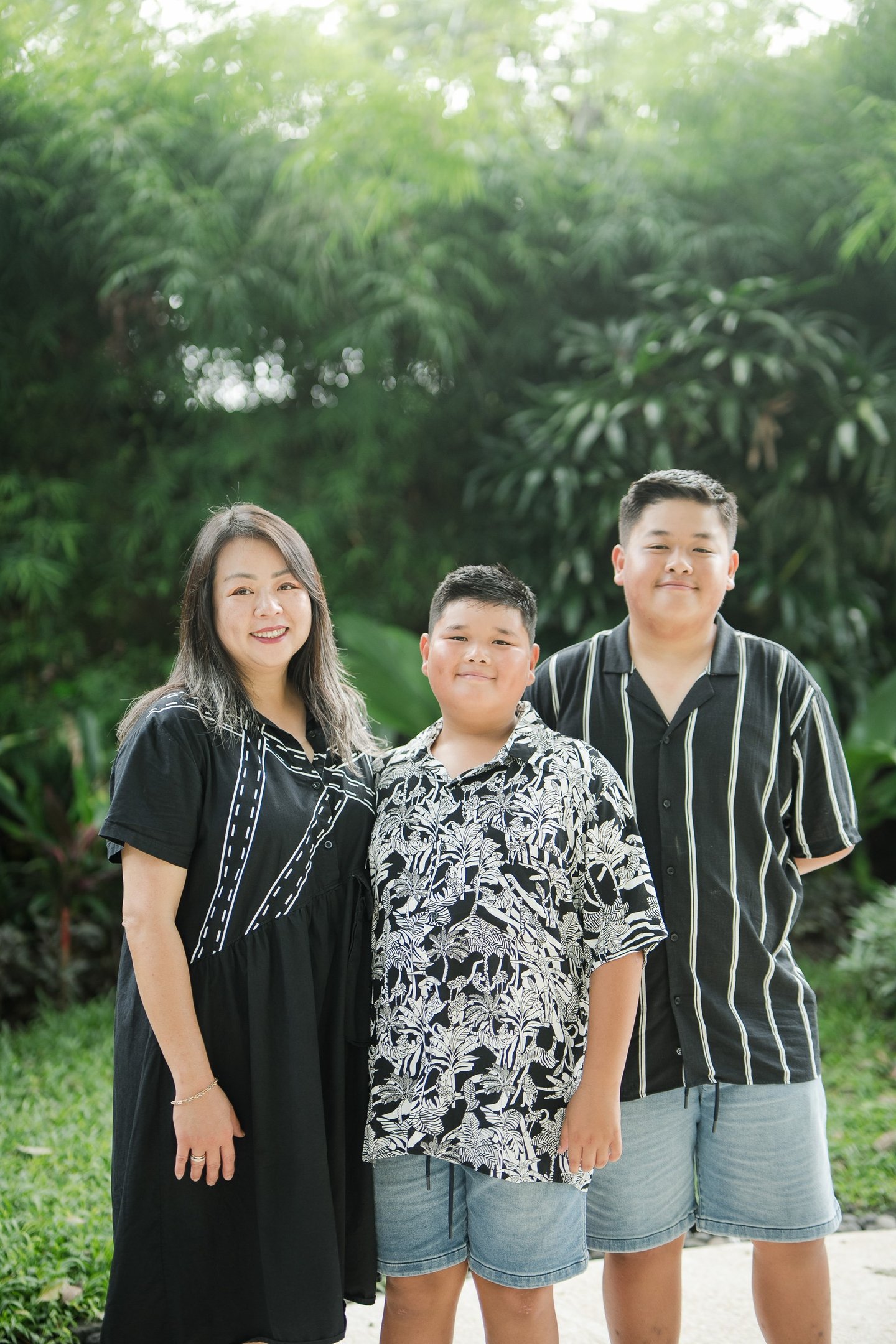 siblings standing together in a relaxed portrait during a family photography session at Movenpick Jimbaran Bali