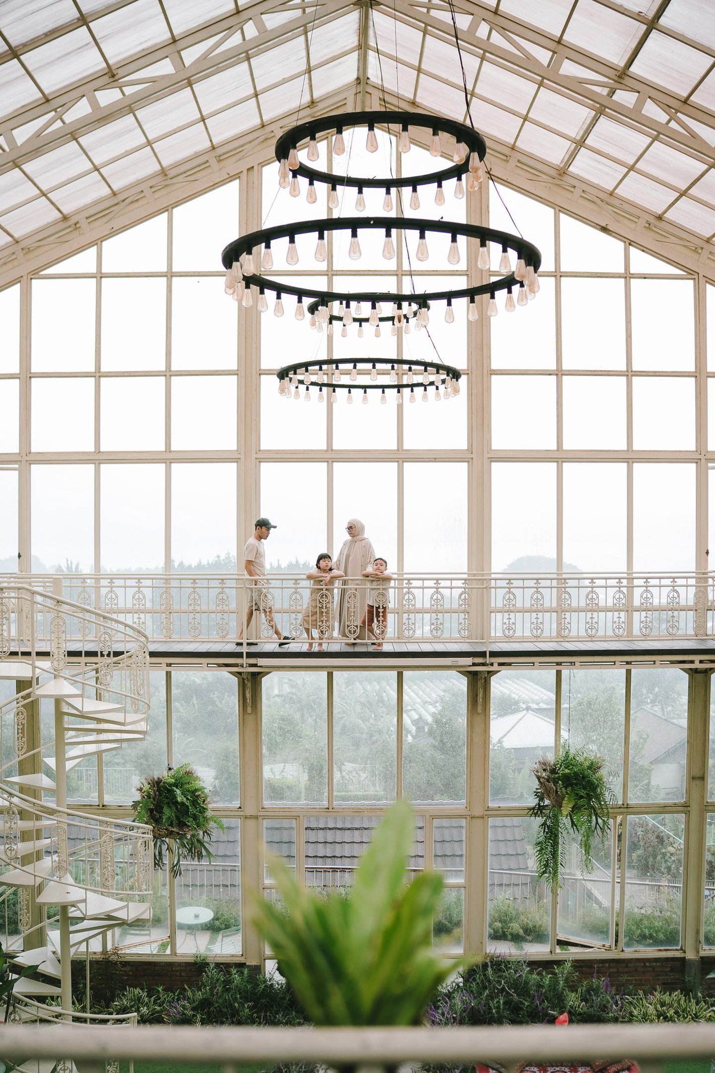 Family walking in rain during a family photography session at Rumah Gemuk Bedugul Bali.