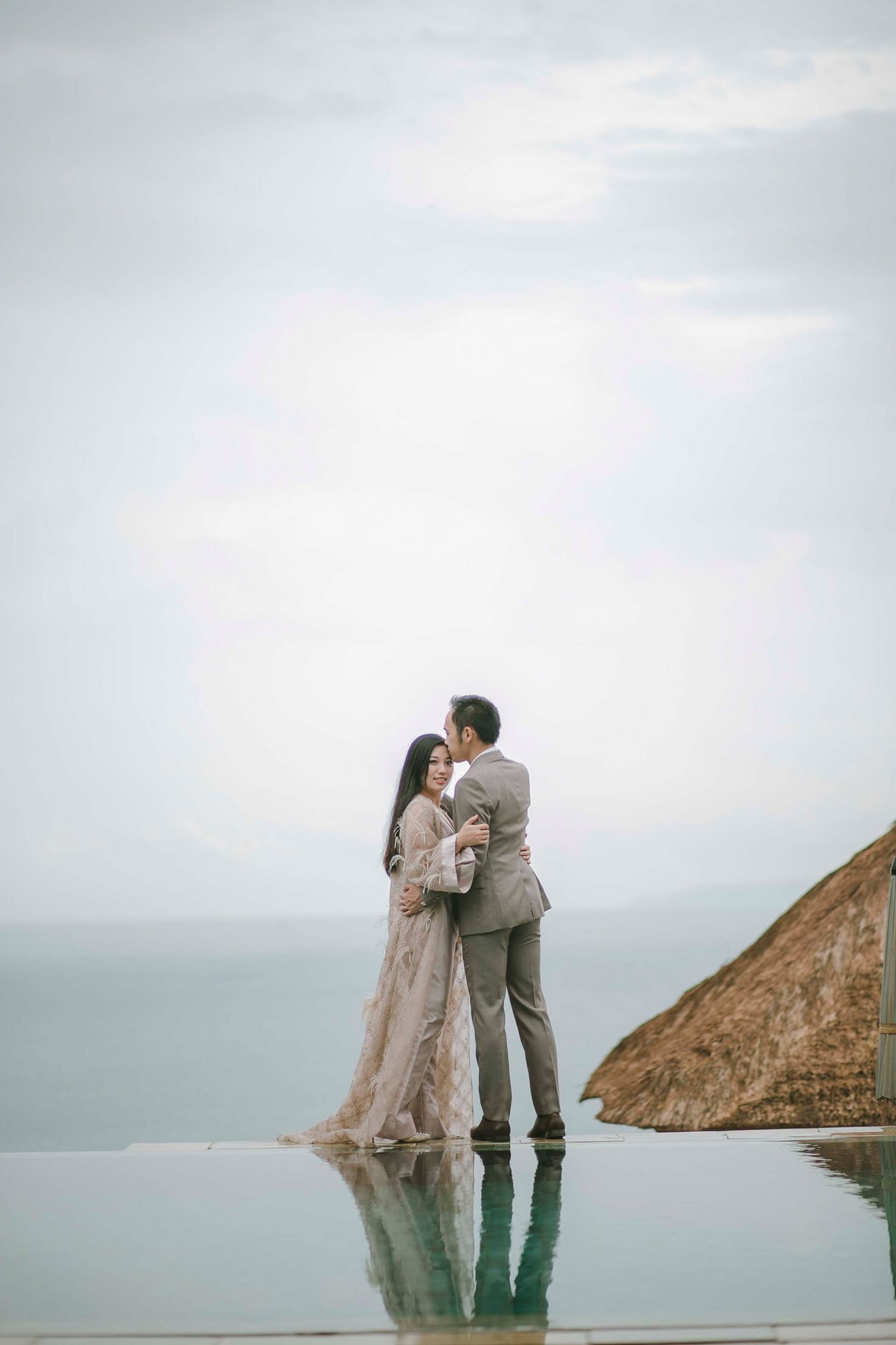 Romantic prewedding couple by cliffside ocean view at Amankila Karangasem Bali