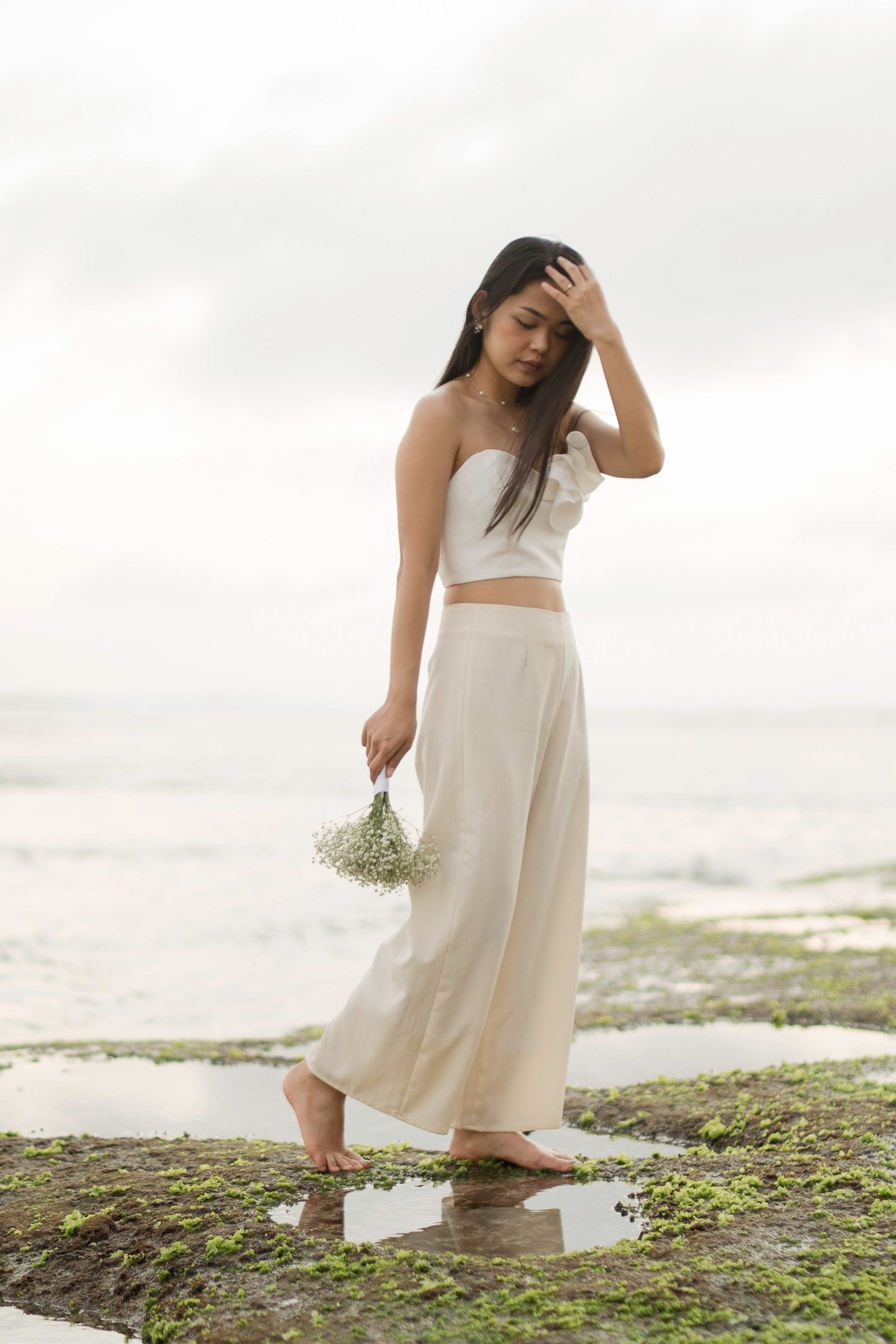 Bachelorette party group portrait with cliffs at Melasti Beach Bali