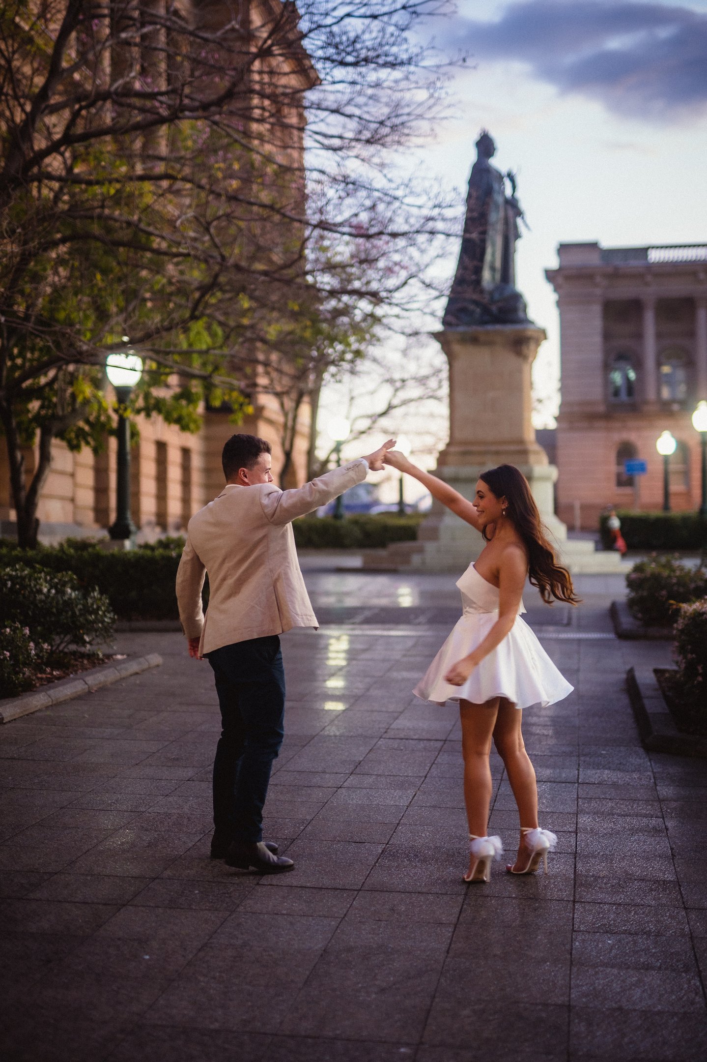 a man and woman dancing in a city