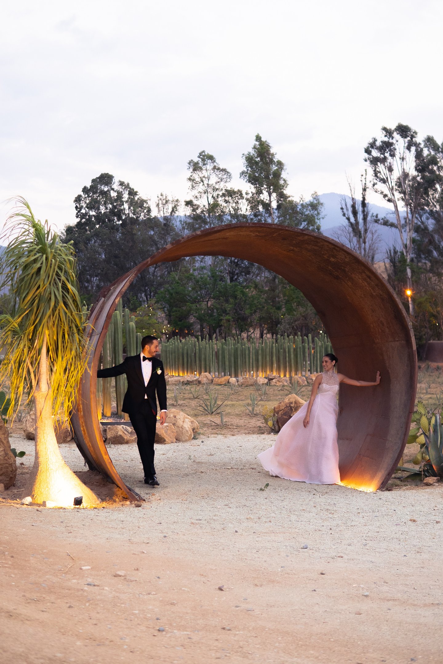 a man in a tuxedo suit and a woman in a pink dress