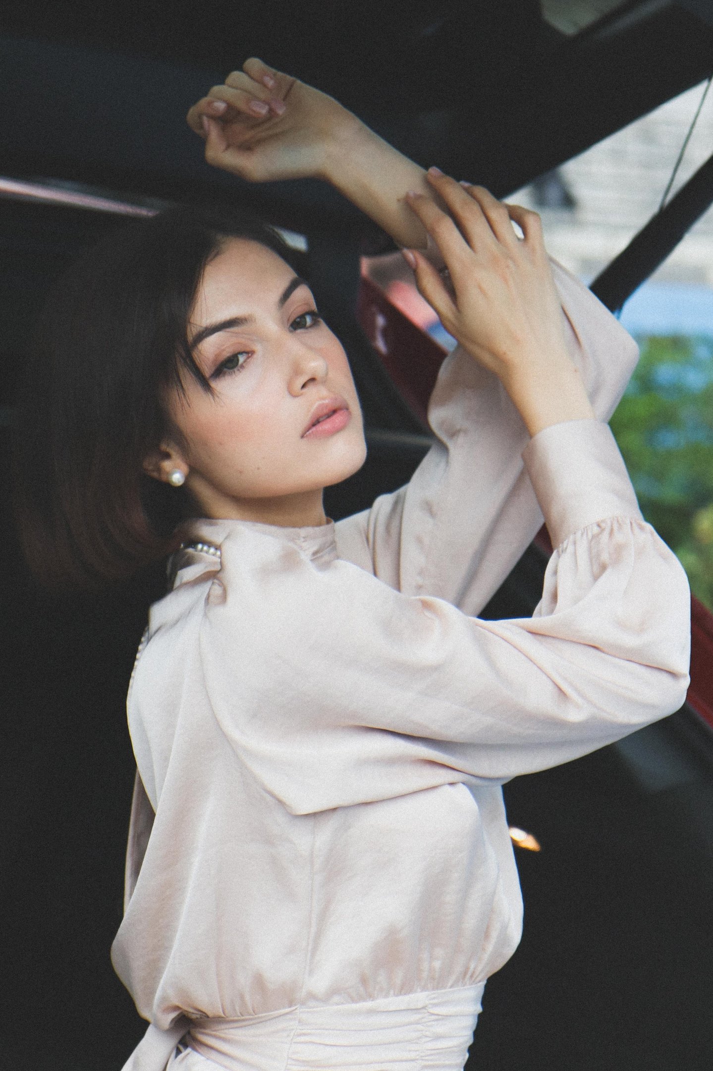 Creative portrait of a woman posing inside a car
