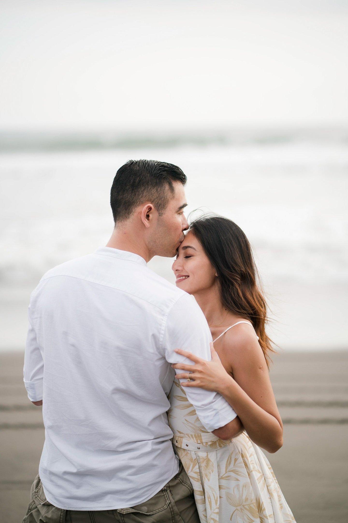 Romantic couple embracing on the beach near Waka Gangga in West Bali