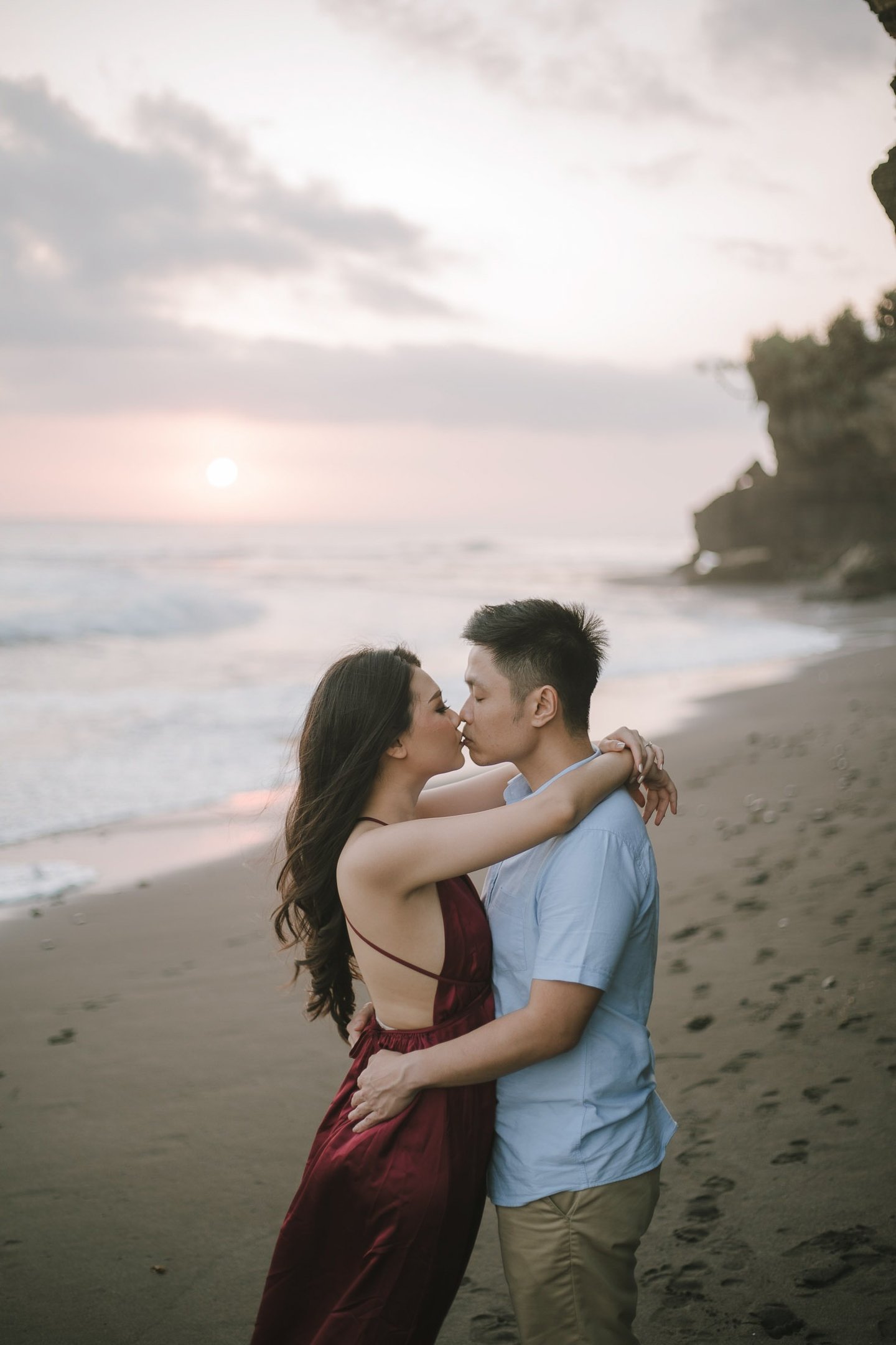 Intimate couple embrace during sunset photography session at Pantai Nyanyi Bali.
