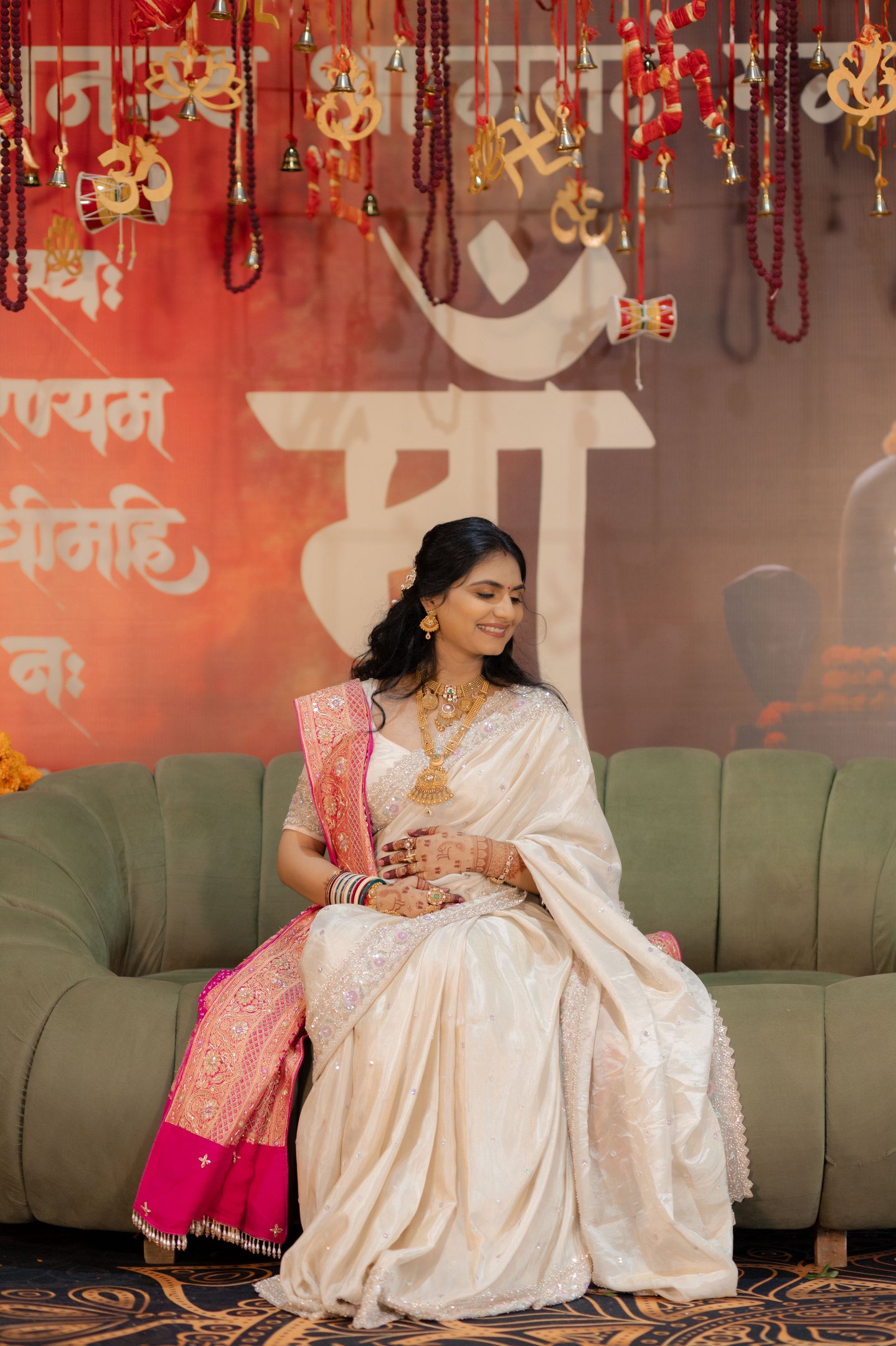 Close-up of a radiant bride's makeup being perfected by R&D Bridal Studio artist for her baby shower