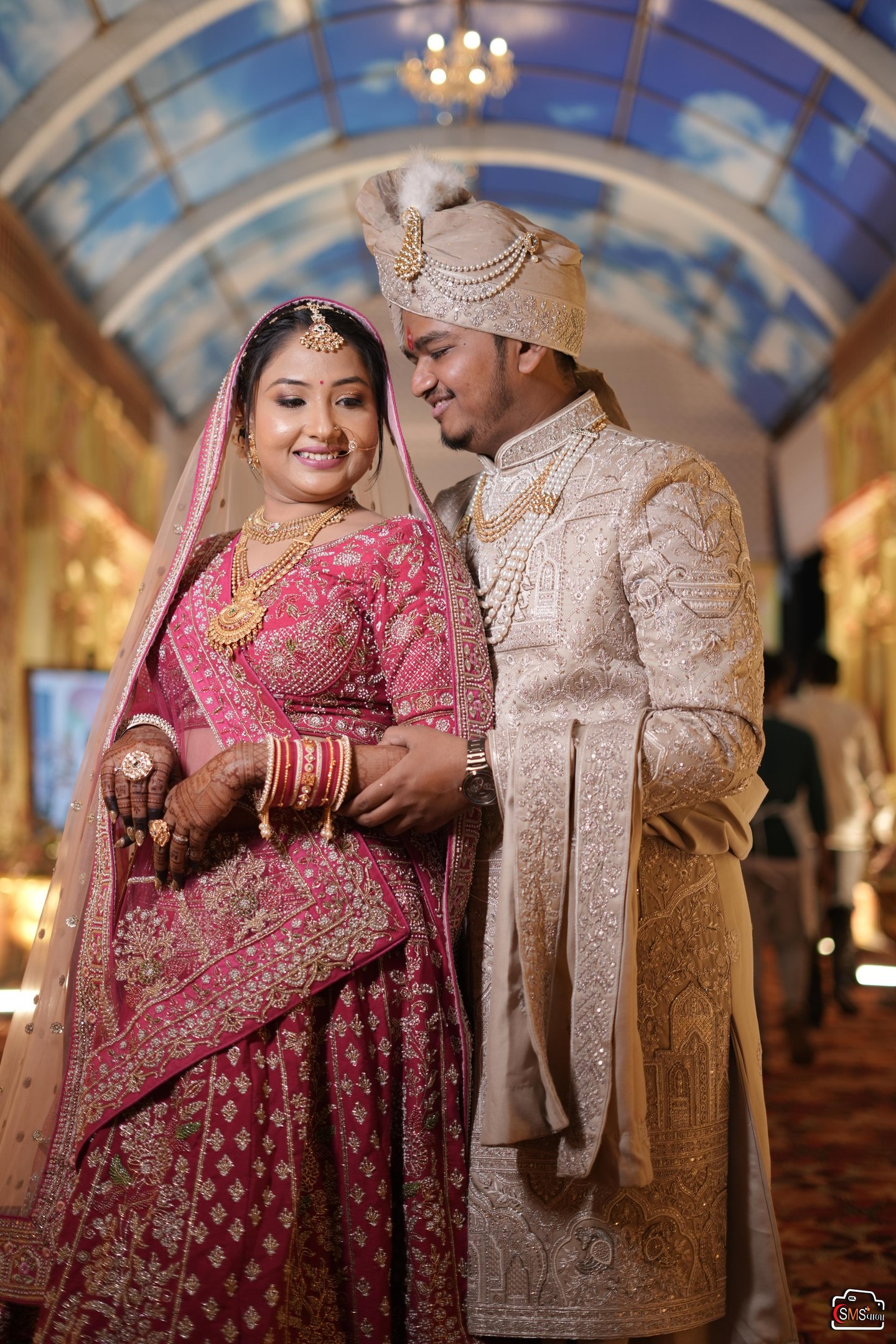 “Traditional red and gold Indian bridal makeup with flawless HD base and classic red lips in Vadodar