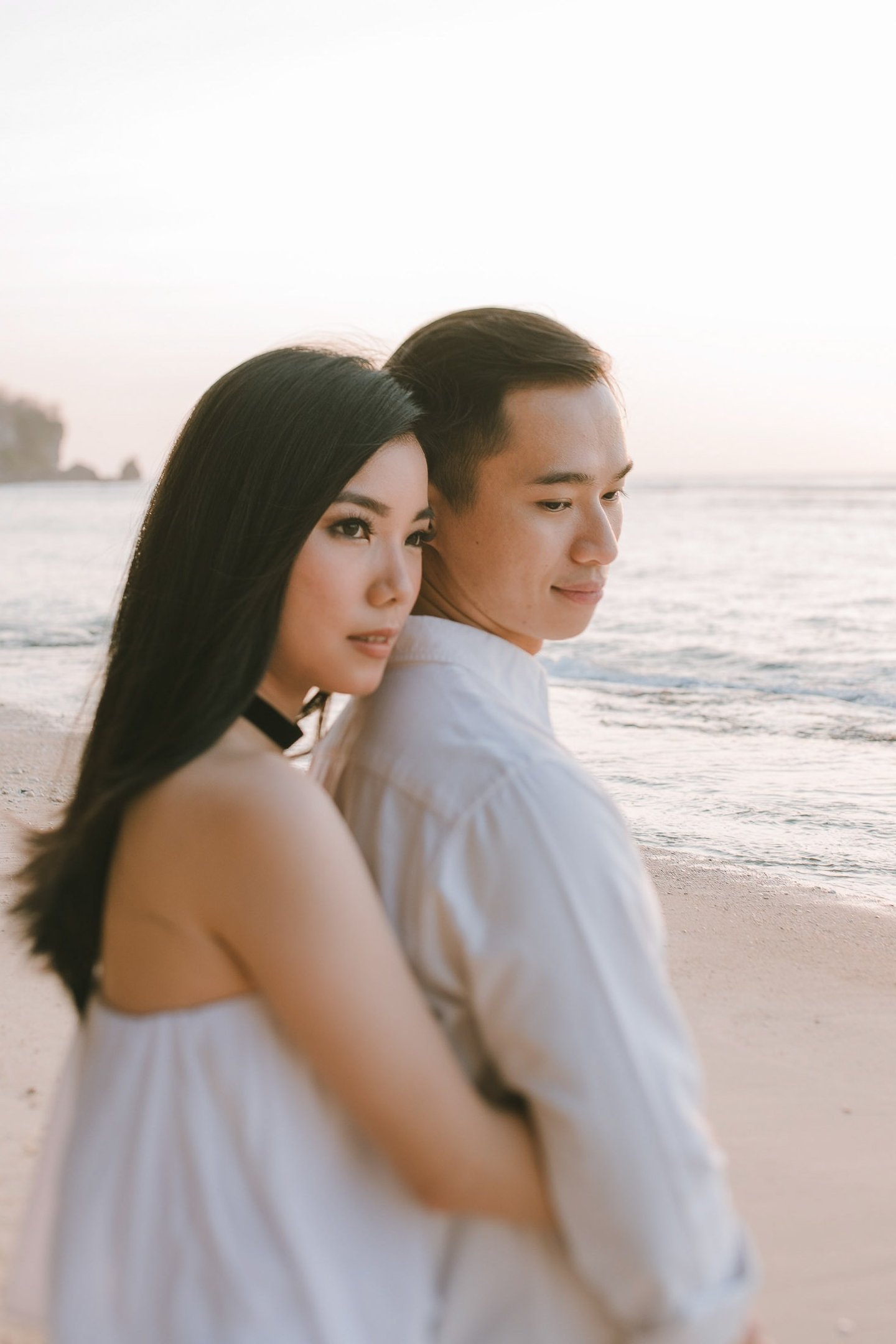 Romantic couple portrait by the beach during a proposal photography session at Anantara Uluwatu Bali Resort.