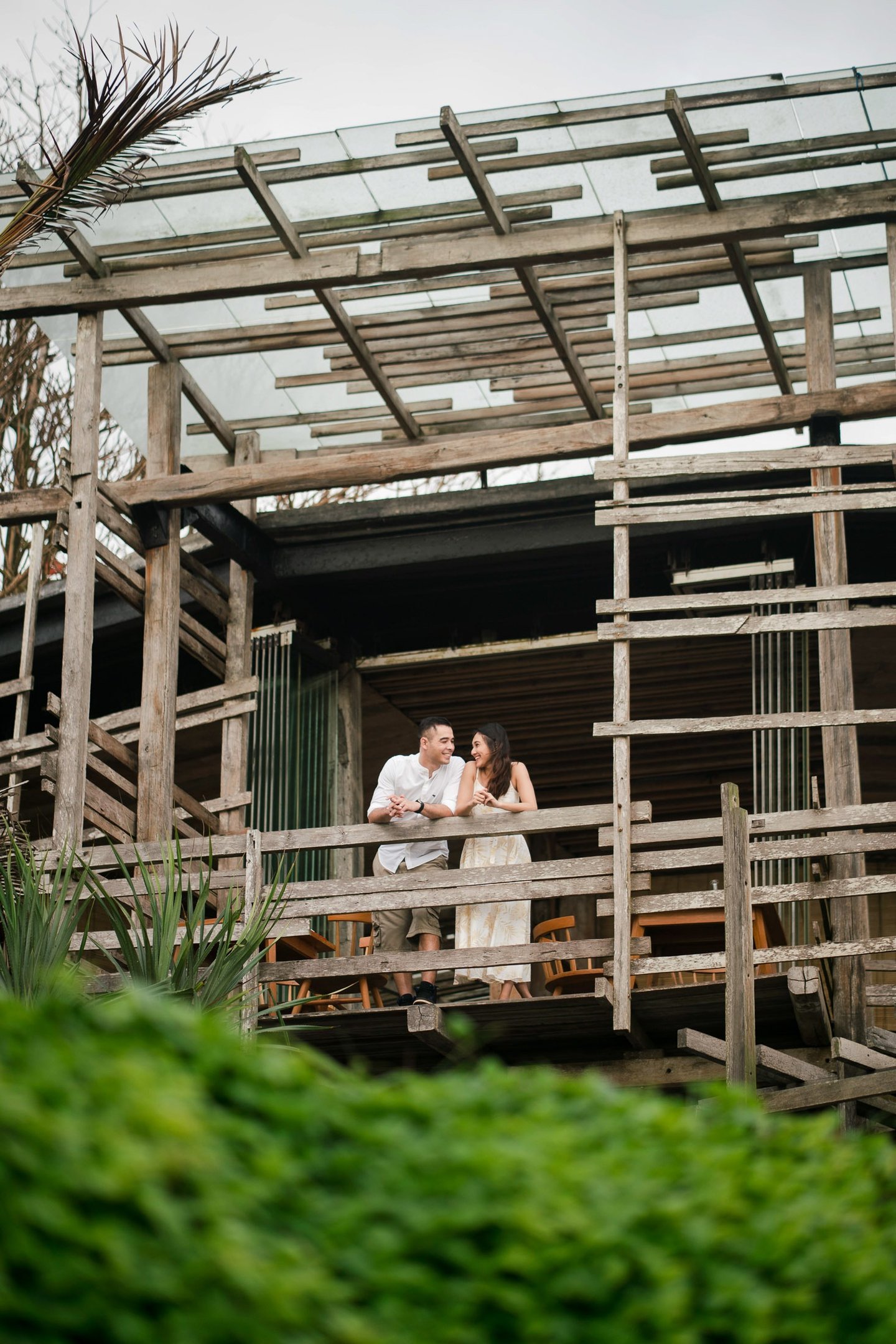Couple sharing quiet moment on wooden balcony at Waka Gangga resort in Tabanan West Bali
