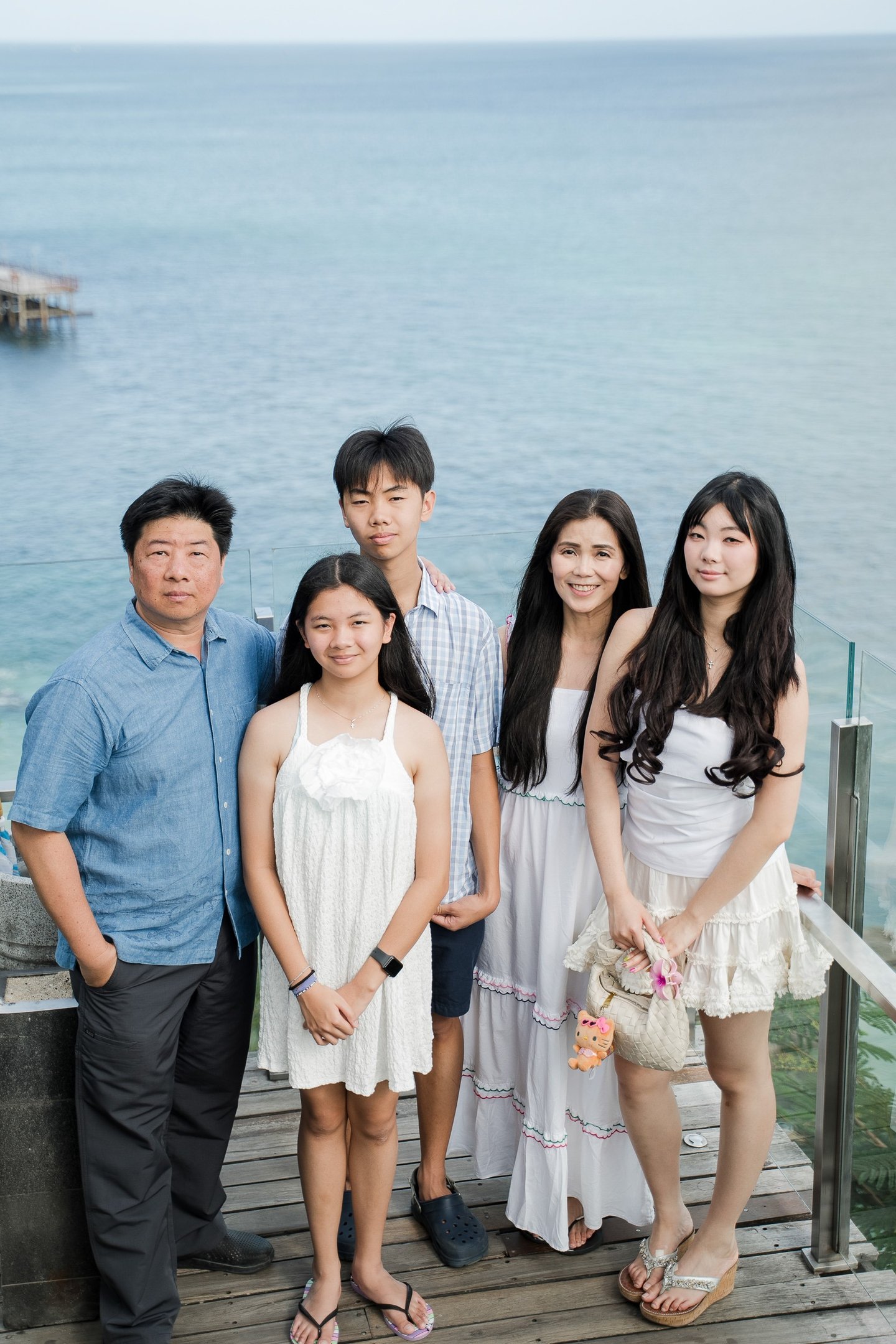 Family portrait on a scenic cliffside with ocean view at Ayana Resort Jimbaran Bali