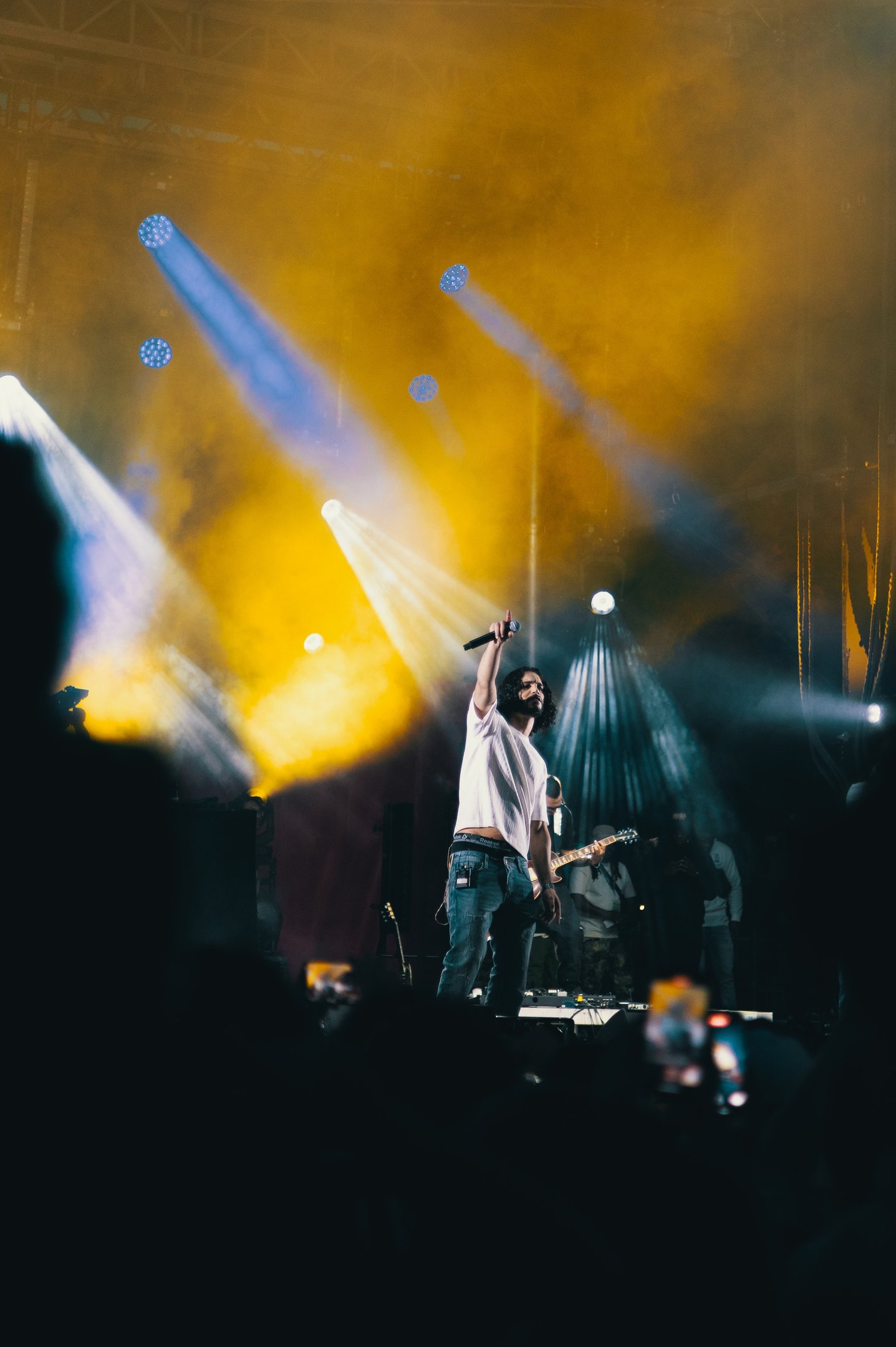 a man standing on a stage with a microphone and a microphone, festival de jazz, montreal