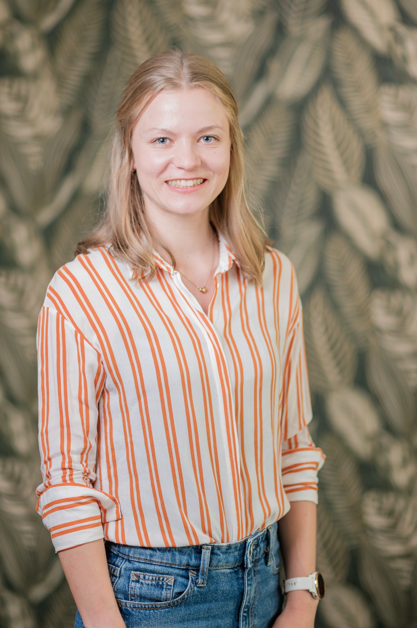 a woman in a striped shirt and jeans