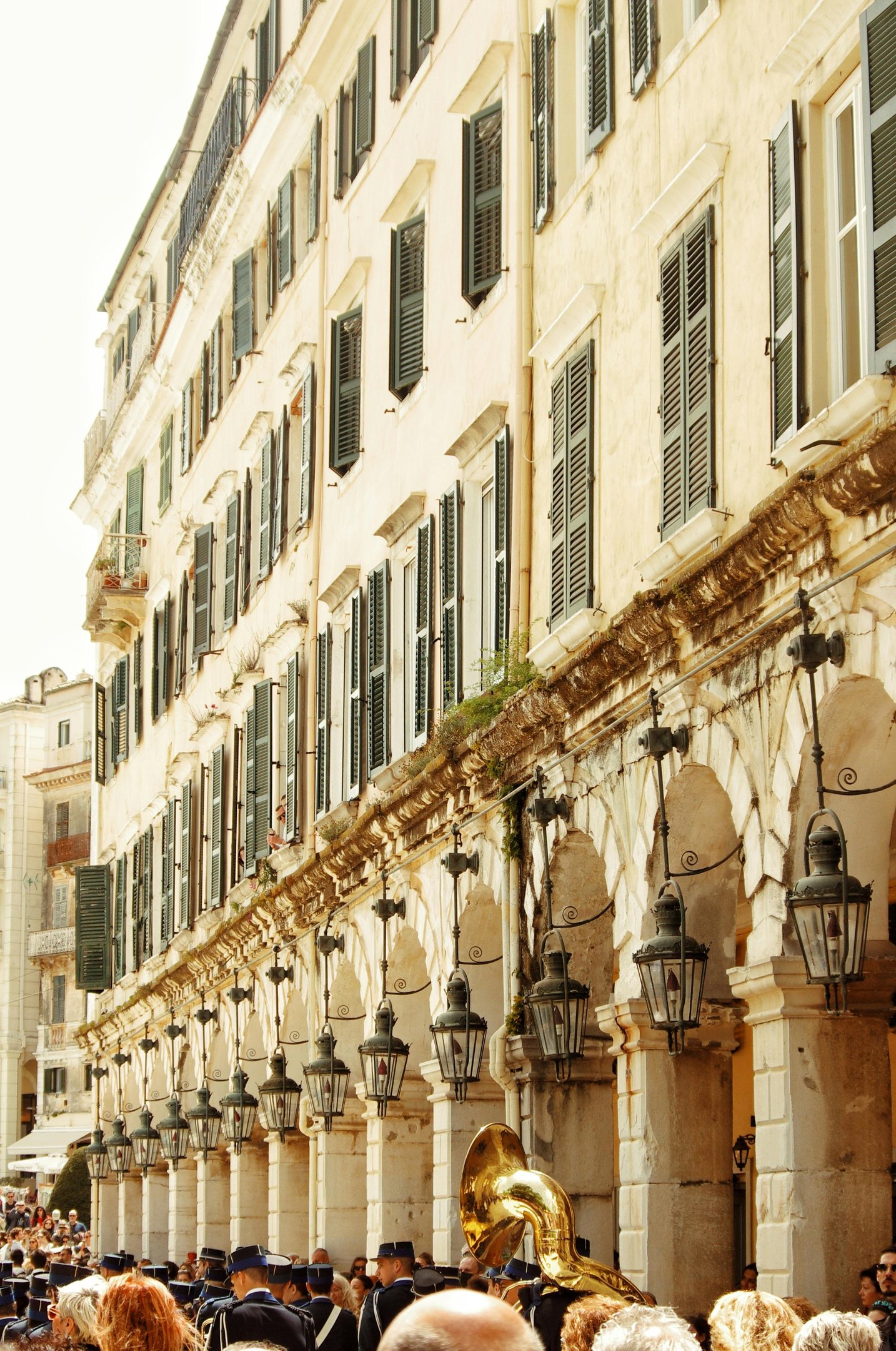 a group of people in uniform marching through a city