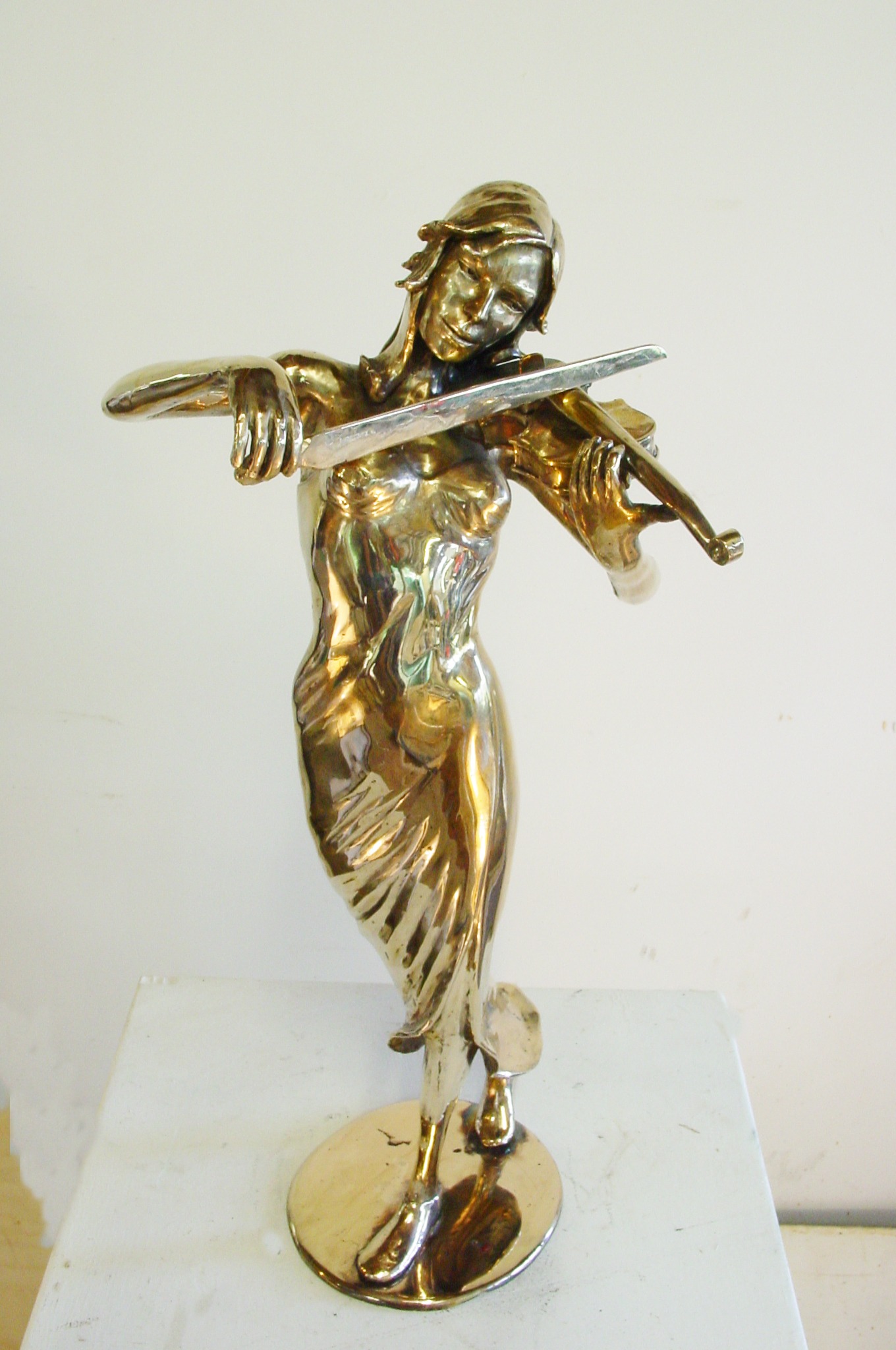 a statue of a woman playing the violin