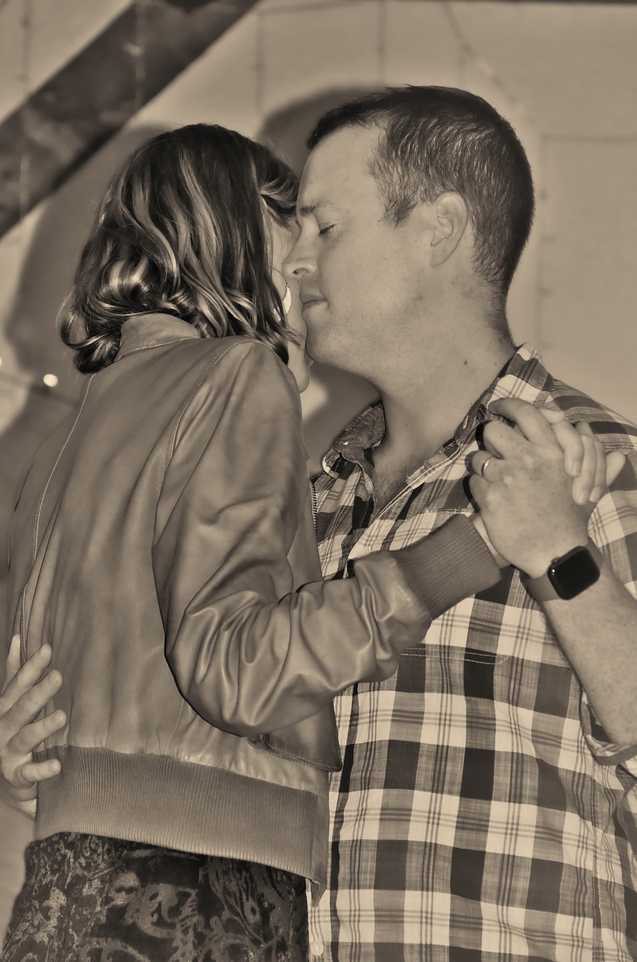 a man and woman dancing and holding each other